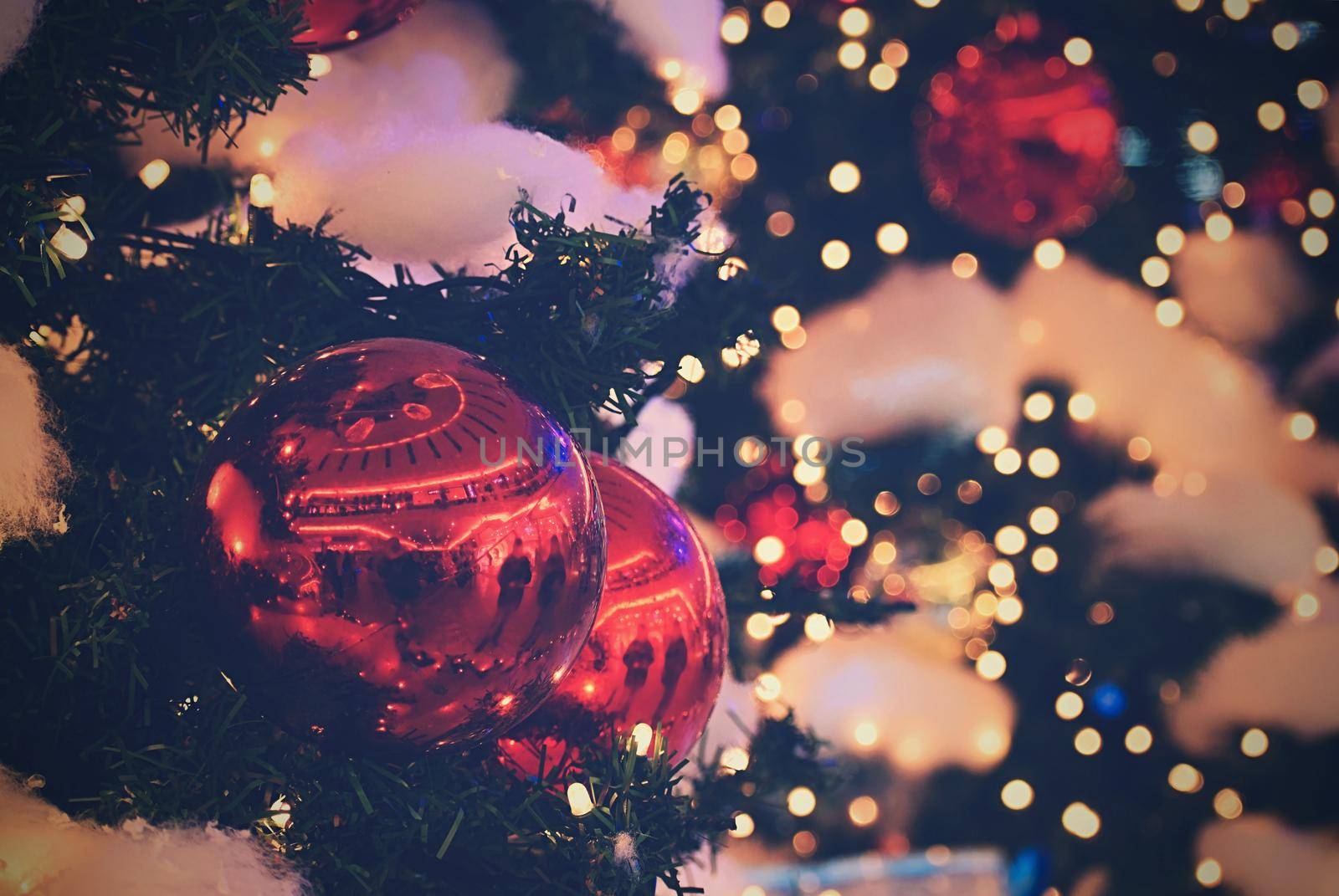 Colorful christmas Decoration. Winter holidays and traditional ornaments on a Christmas tree. Lighting chains - candles for seasonal background.