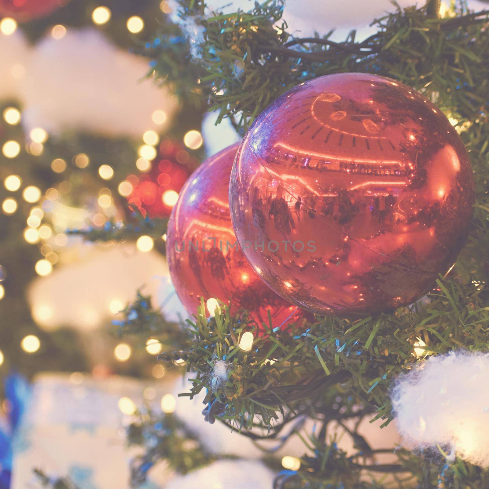 Colorful christmas Decoration. Winter holidays and traditional ornaments on a Christmas tree. Lighting chains - candles for seasonal background.