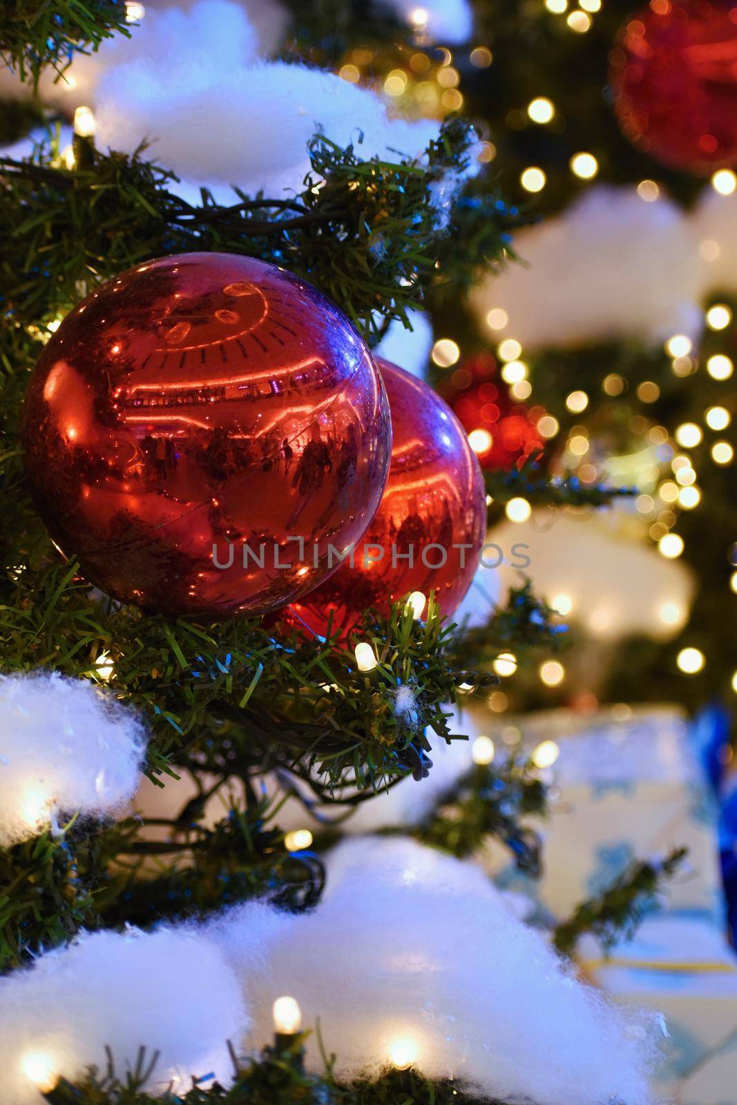 Colorful christmas Decoration. Winter holidays and traditional ornaments on a Christmas tree. Lighting chains - candles for seasonal background. by Montypeter