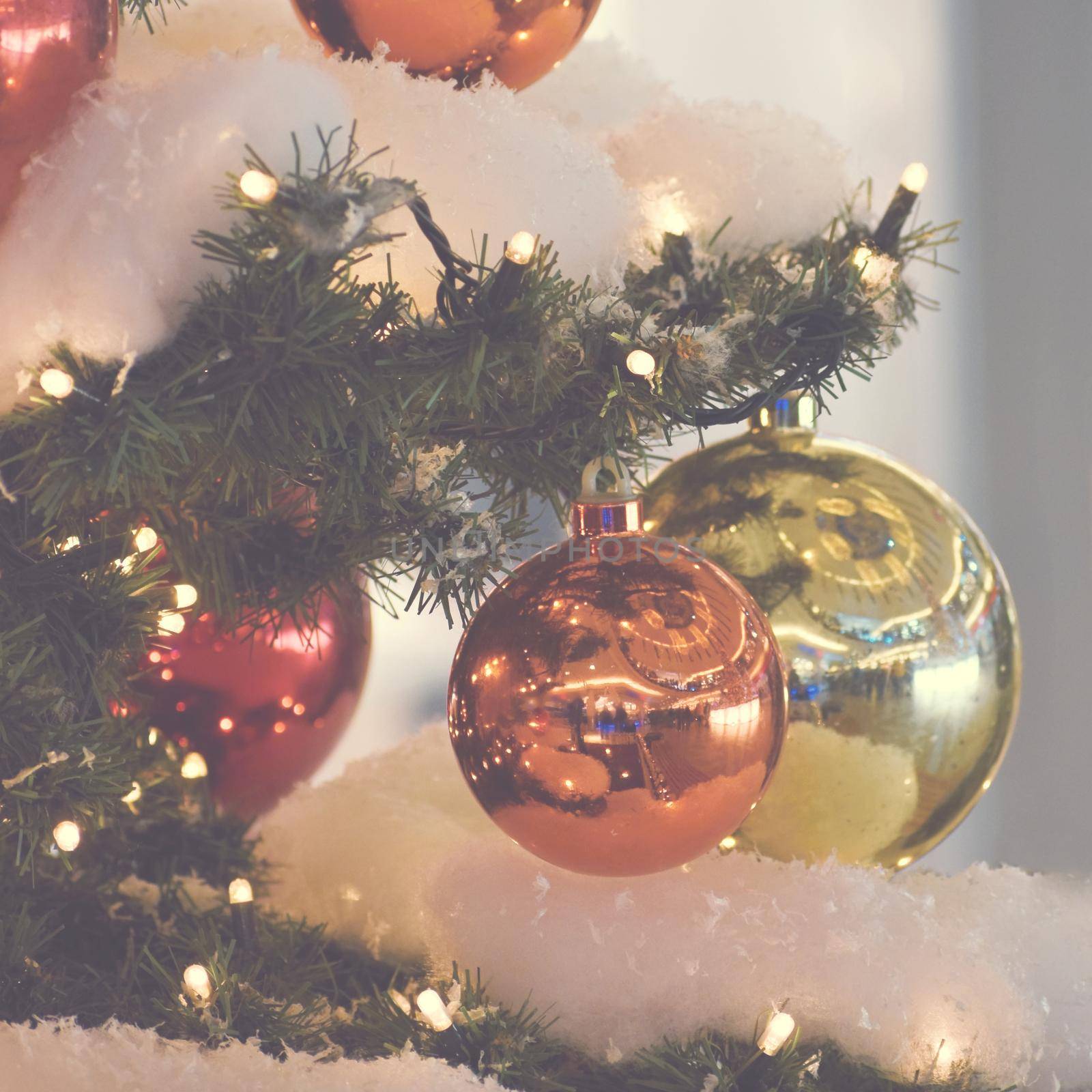 Colorful christmas Decoration. Winter holidays and traditional ornaments on a Christmas tree. Lighting chains - candles for seasonal background.