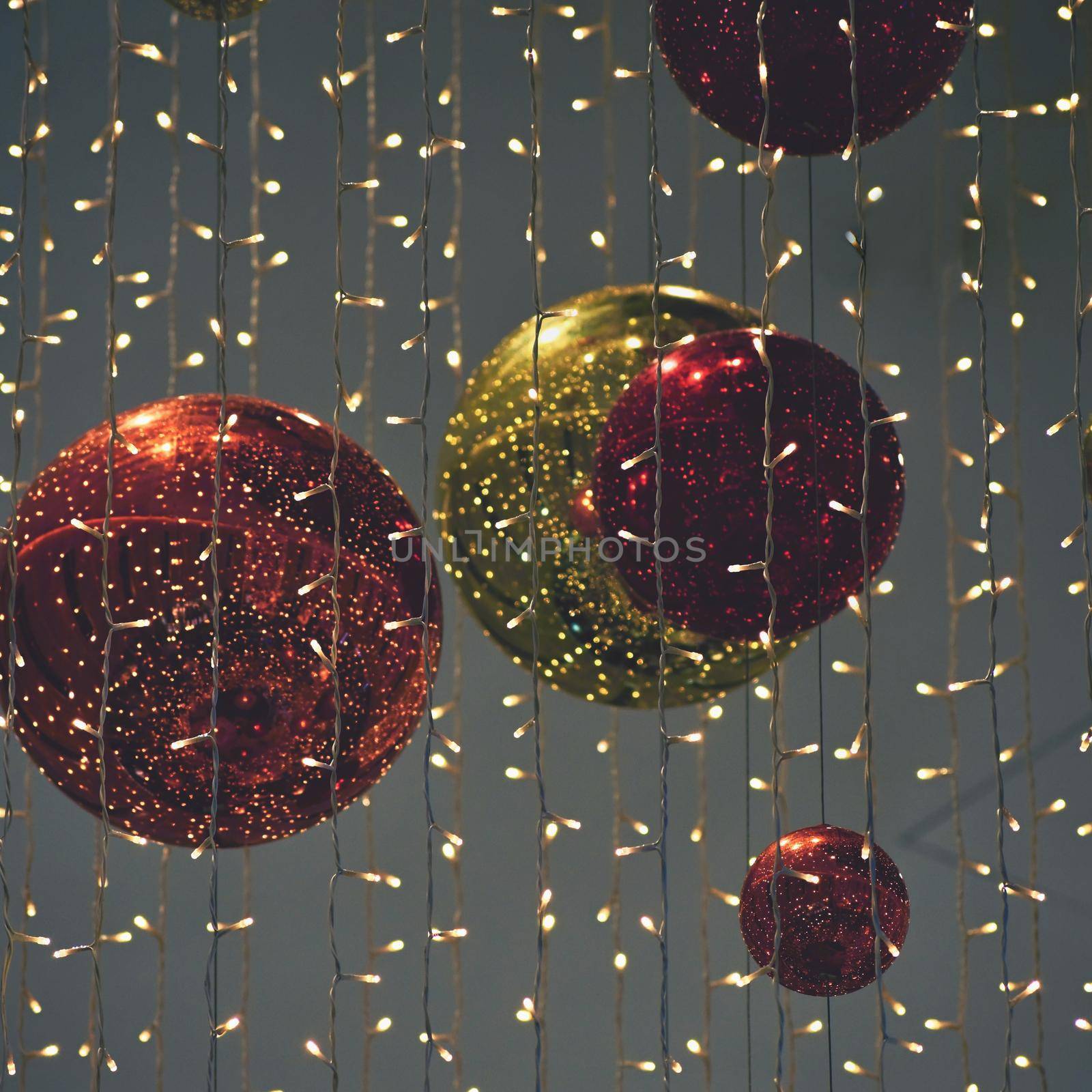 Colorful christmas Decoration. Winter holidays and traditional ornaments on a Christmas tree. Lighting chains - candles for seasonal background.