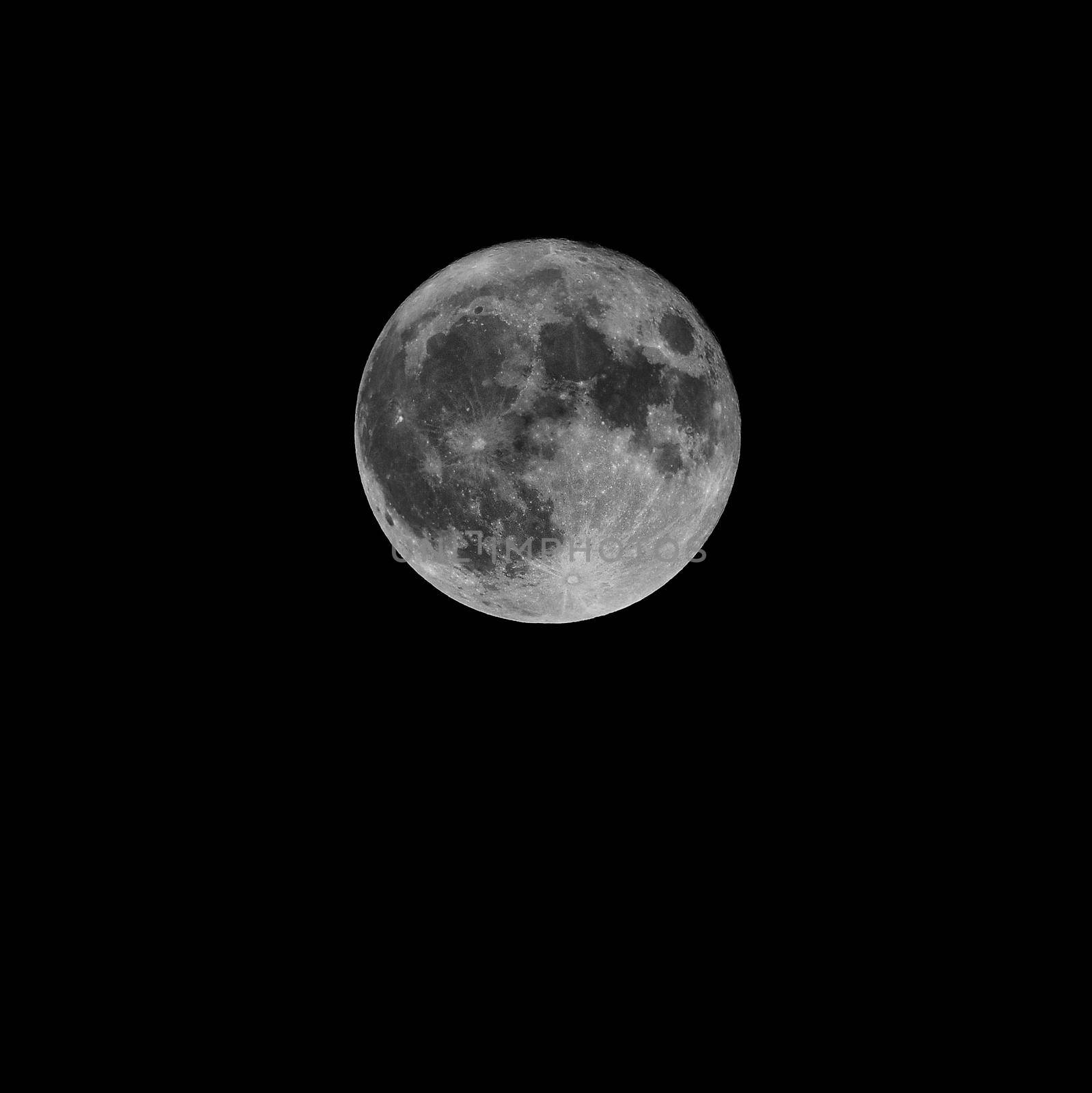 Full moon over dark black sky at night