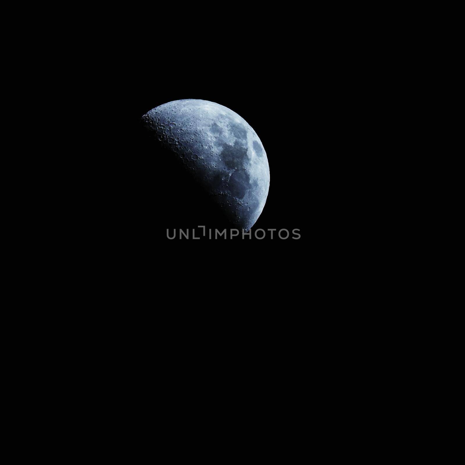 Moon over dark black sky at night by Montypeter