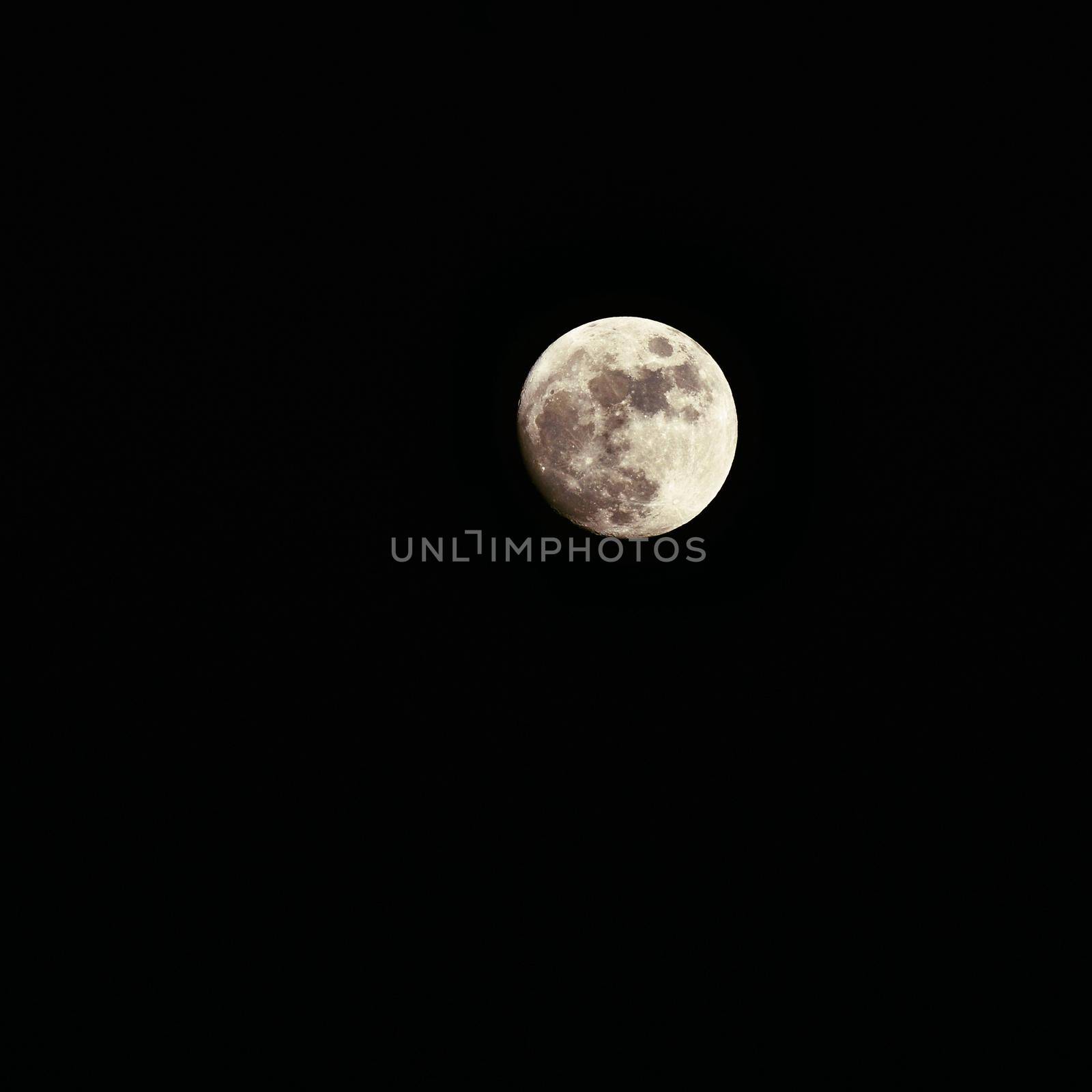 Full moon over dark black sky at night