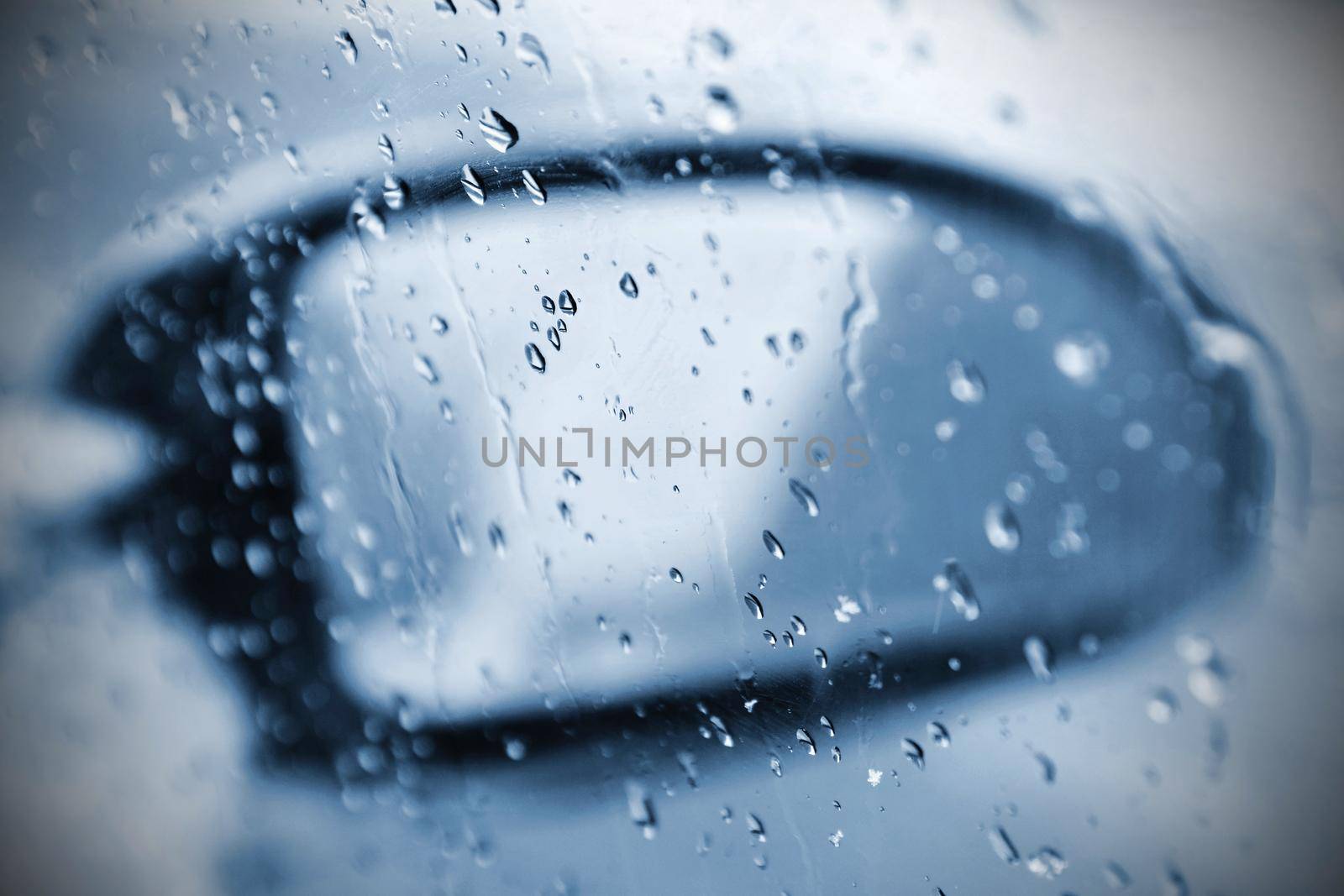 Winter car, the concept of winter car ride. Mirror and ice and water drops on the windscreen. by Montypeter