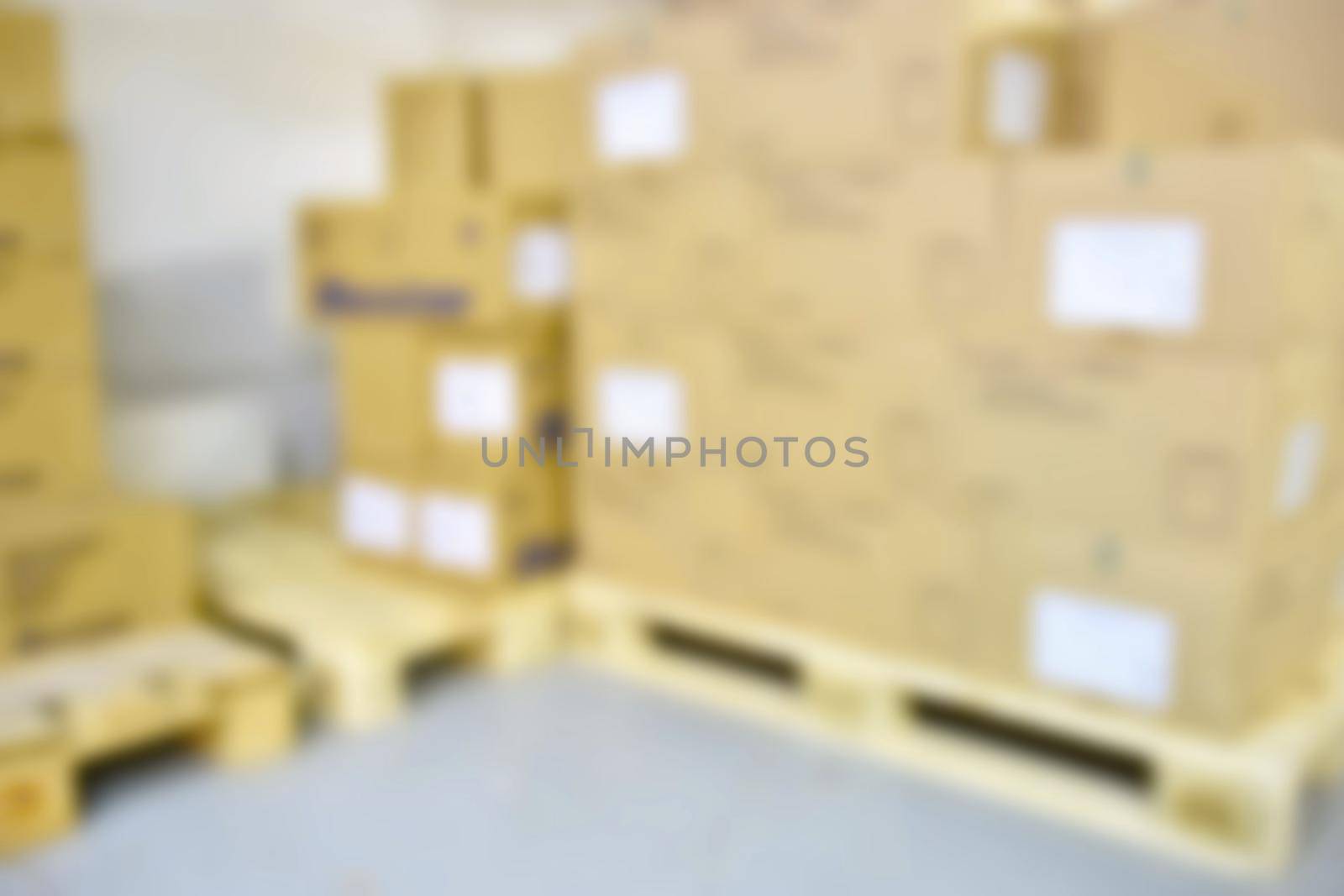 Blurred background warehouse. Abstract blurry warehouse storing. The interior of the warehouse with boxes and pallets. by Montypeter