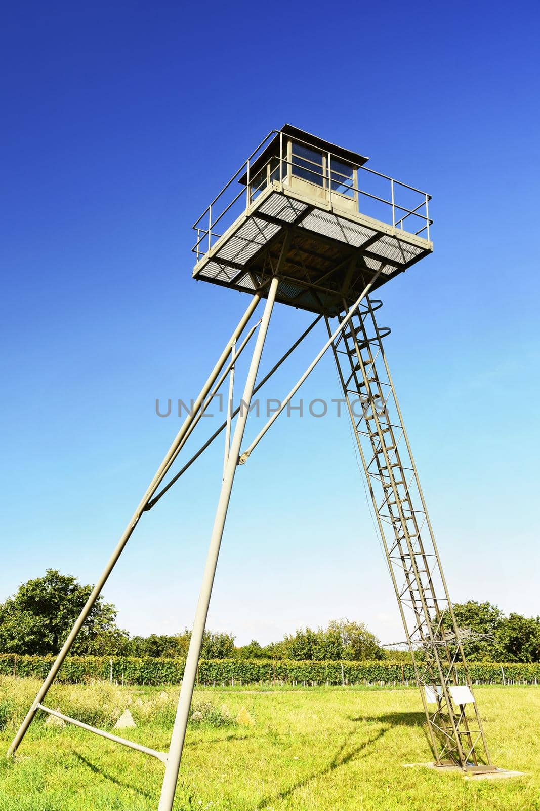 Watchtower and line of defense, old state border of the Iron Curtain - barbed fence. Memorial military area - Satov Czech Republic. by Montypeter