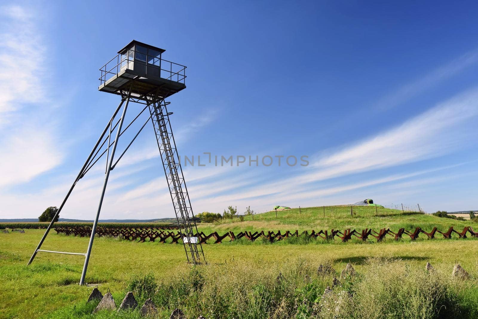 Watchtower and line of defense, old state border of the Iron Curtain - barbed fence. Memorial military area - Satov Czech Republic.