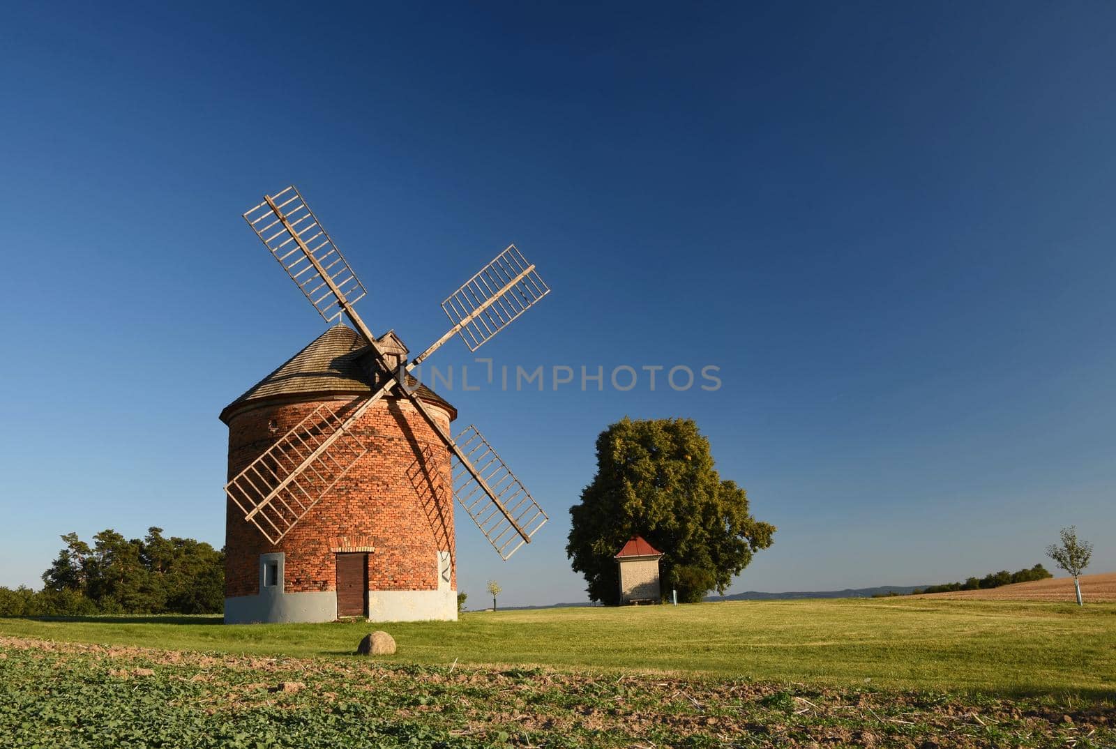 Beautiful old windmill and landscape with the sun. Chvalkovice - Czech Republic. Europe.