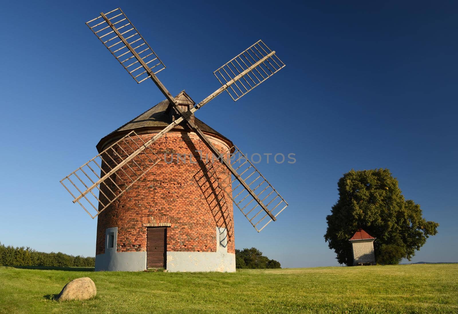 Beautiful old windmill and landscape with the sun. Chvalkovice - Czech Republic. Europe. by Montypeter