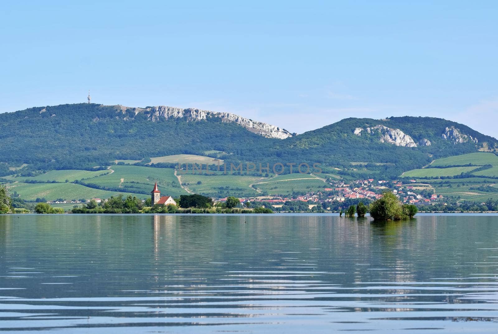 The island with the old church in the middle of the lake. Landscape under Palava. Czech Republic - South Moravian Region wine region. Water tank - New Mills - Pasohlavky. by Montypeter