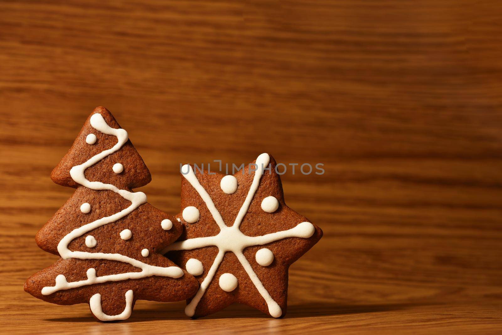 Christmas tree and snowflake. Beautiful sweet Christmas candy. Hand-decorated, homemade gingerbread.