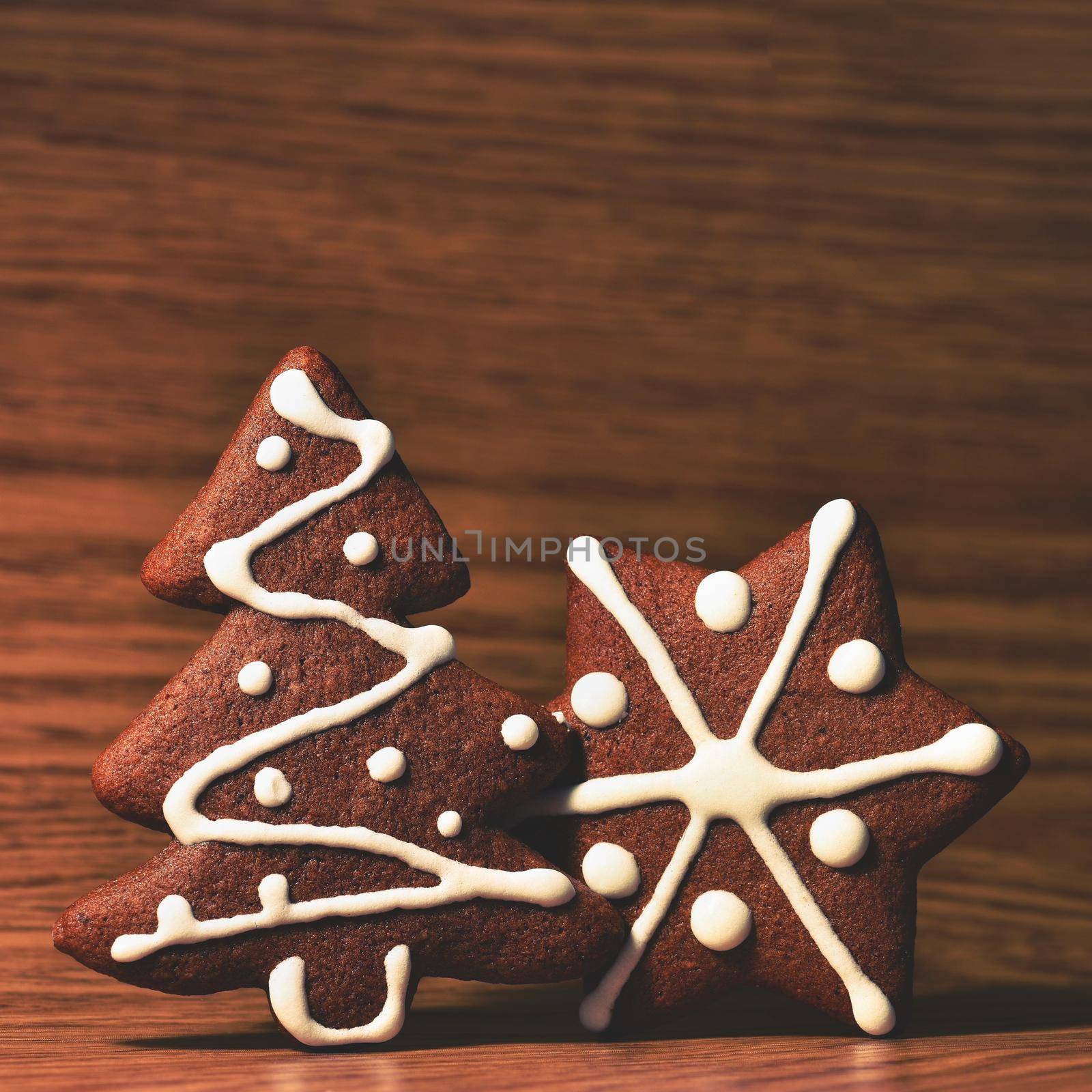 Christmas tree and snowflake. Beautiful sweet Christmas candy. Hand-decorated, homemade gingerbread.