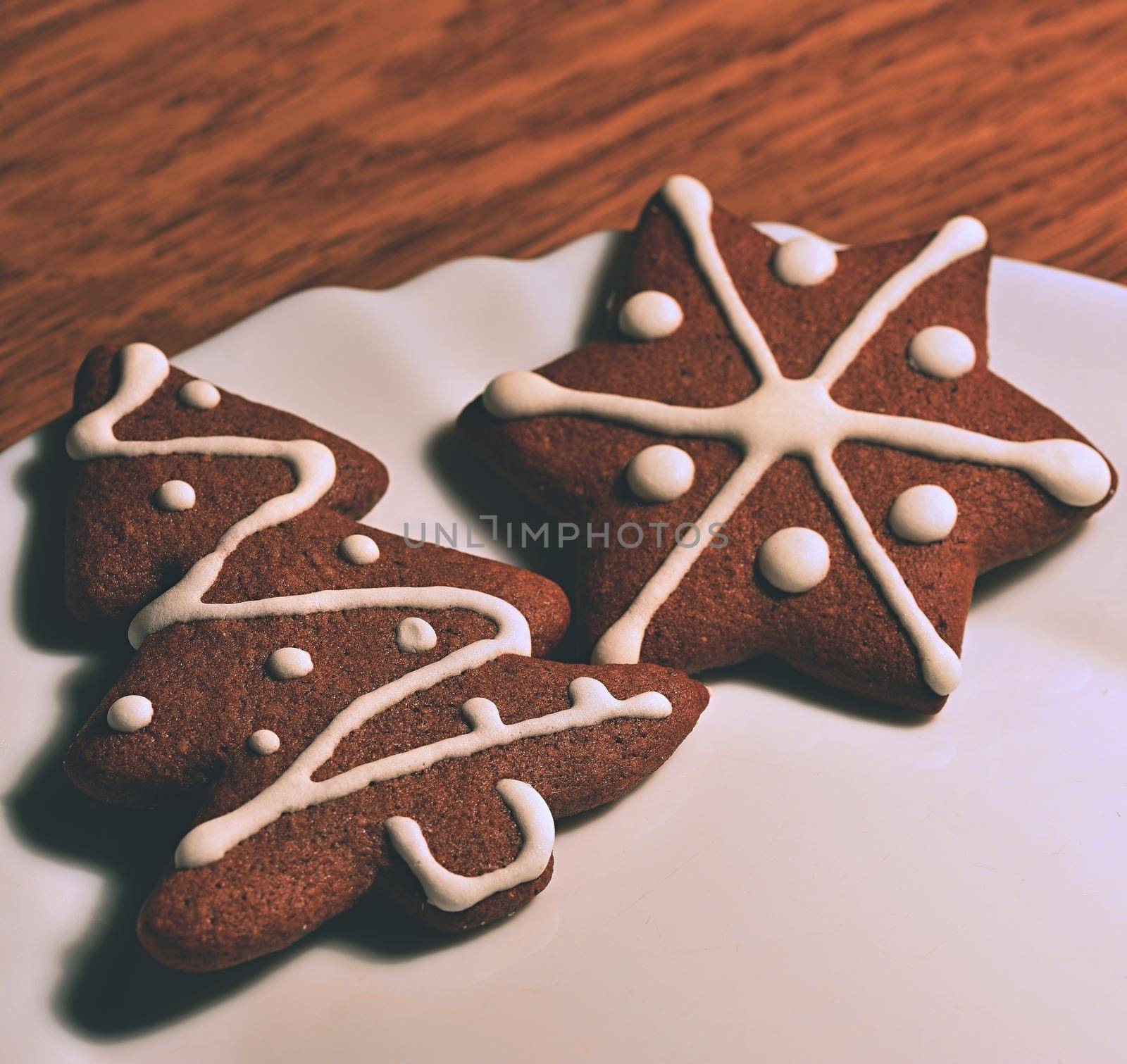 Christmas tree and snowflake. Beautiful sweet Christmas candy. Hand-decorated, homemade gingerbread.