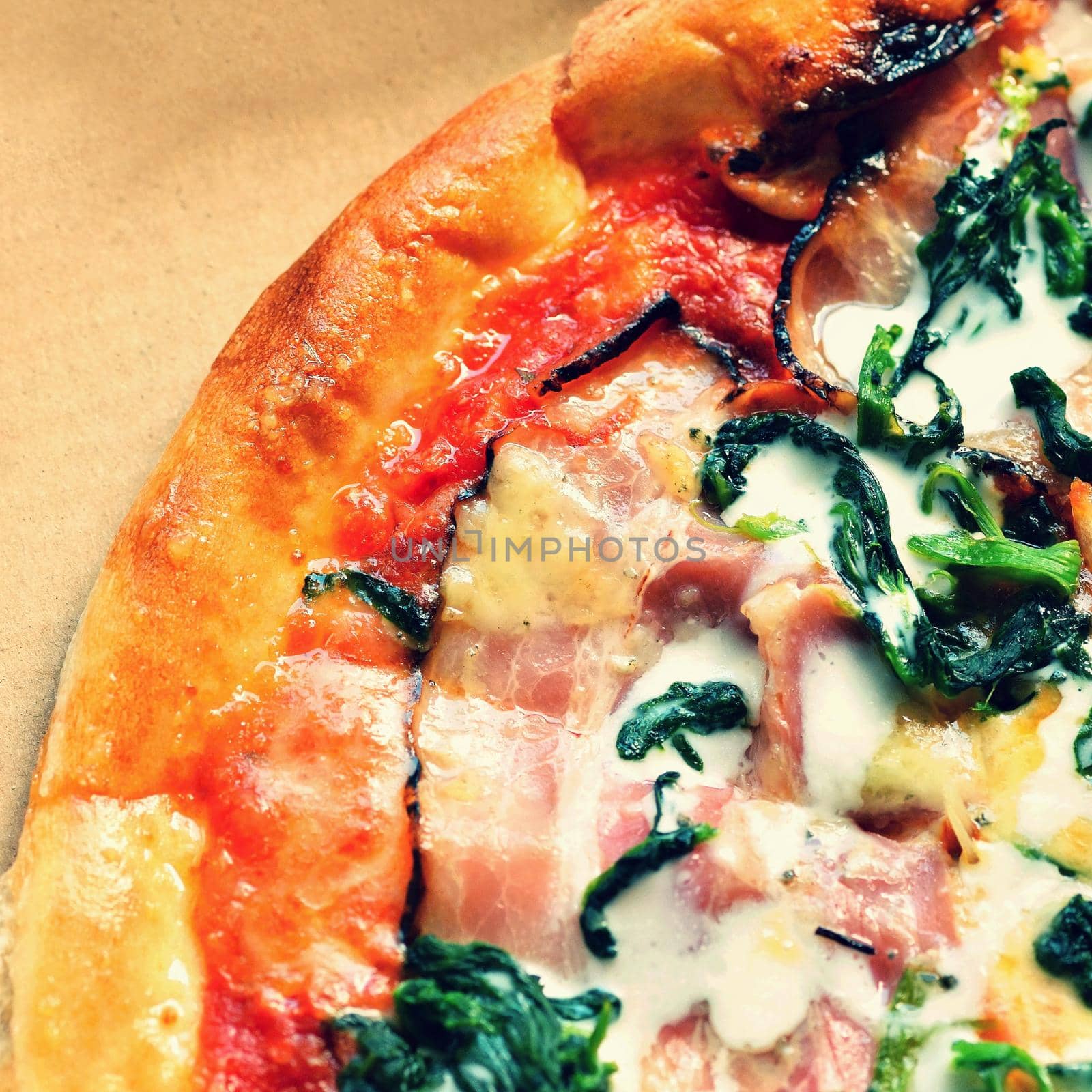 Excellent fresh pizza with cheese, bacon, cream and spinach. Tasty Fast Italian Food.