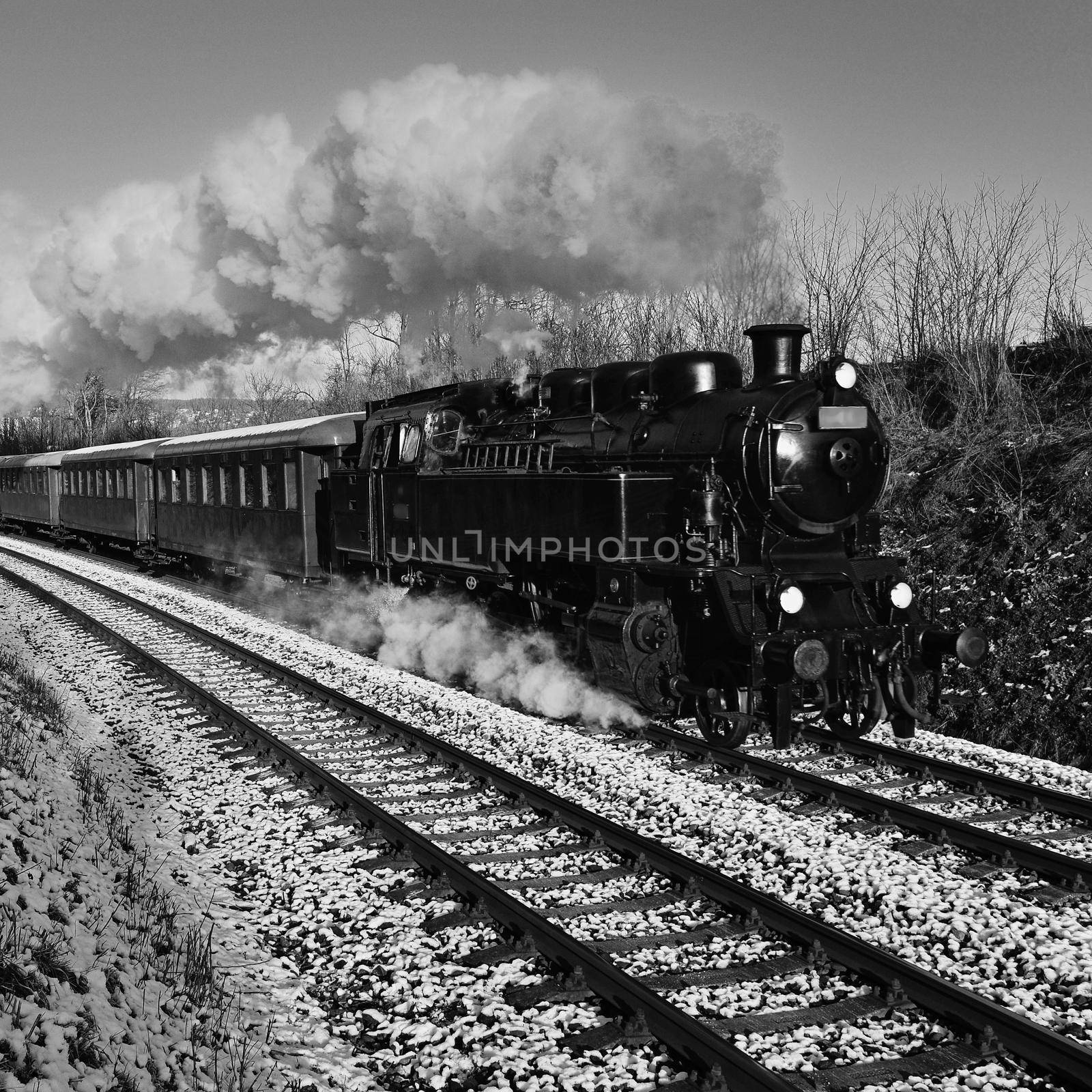 Beautiful old steam train with wagons running on rails at sunset. Excursions for children and parents on festive special days. Czech Republic Europe.