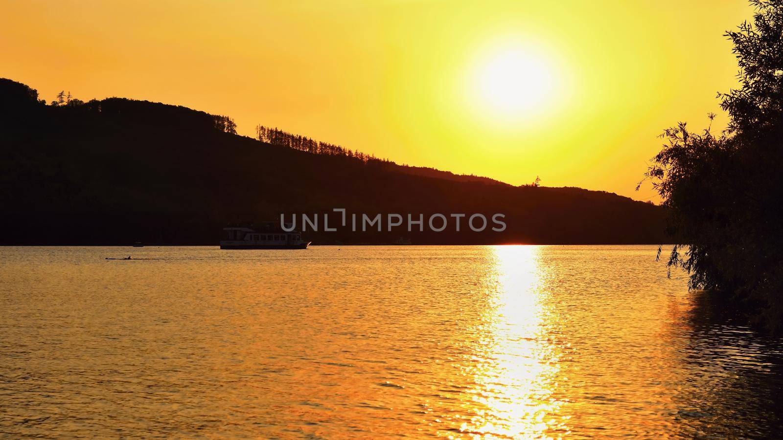 Brno dam. The city of Brno-Europe. Beautiful sunset by water with a boat. by Montypeter
