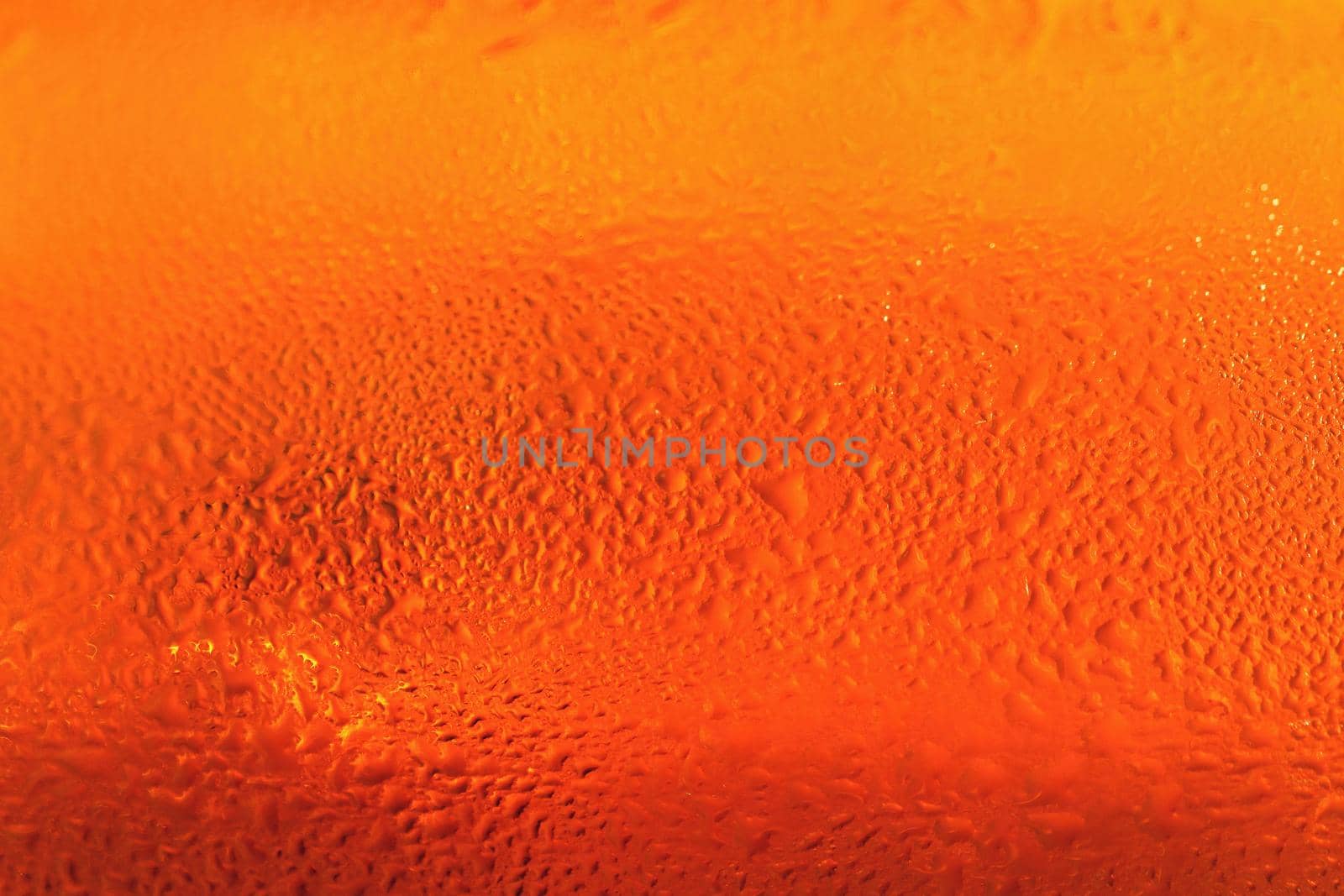 Beer. Beautiful detail of beaten glass of beer with foam. Abstract colorful background. by Montypeter