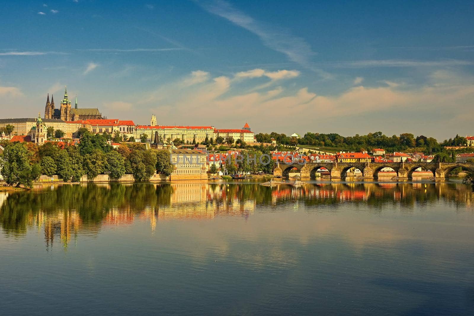 Prague, capital of the Czech Republic. Scenic sunset view of the Old Town pier architecture and Charles Bridge over Vltava river.  by Montypeter