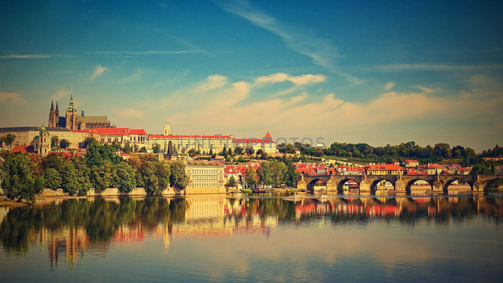 Prague, capital of the Czech Republic. Scenic sunset view of the Old Town pier architecture and Charles Bridge over Vltava river. 