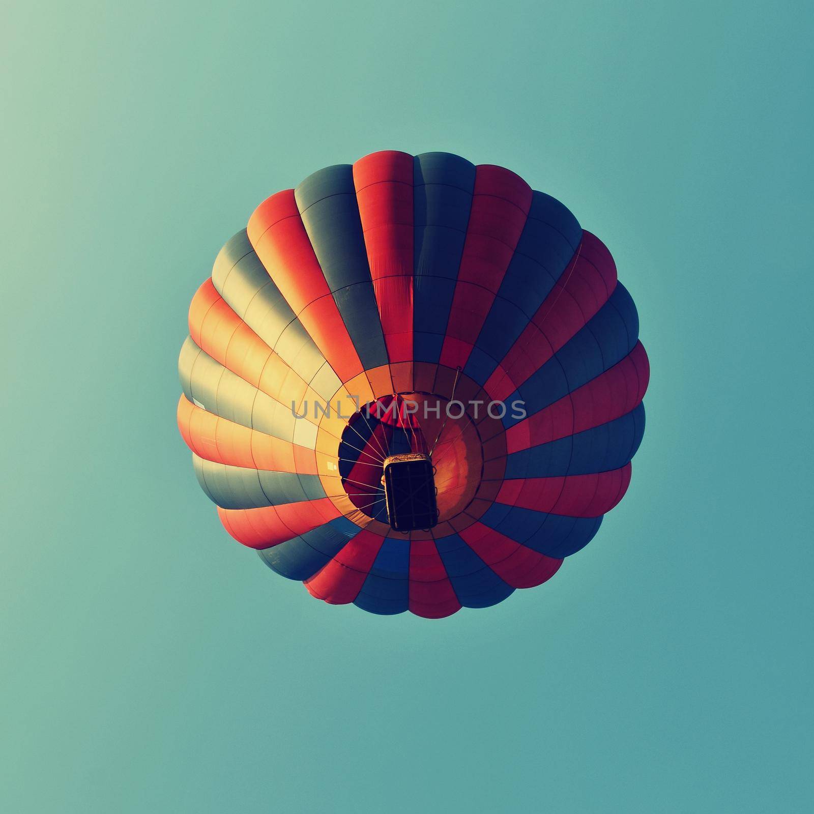 Colorful hot air balloon is flying at sunset. Natural colorful background with sky.