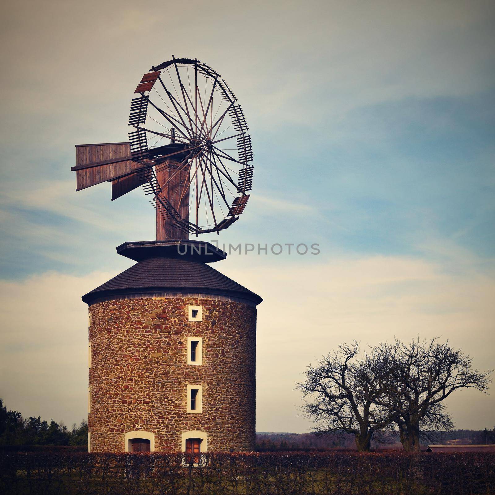 Beautiful old windmill at sunset with sky and clouds. Ruprechtov - Czech Republic - Europe.