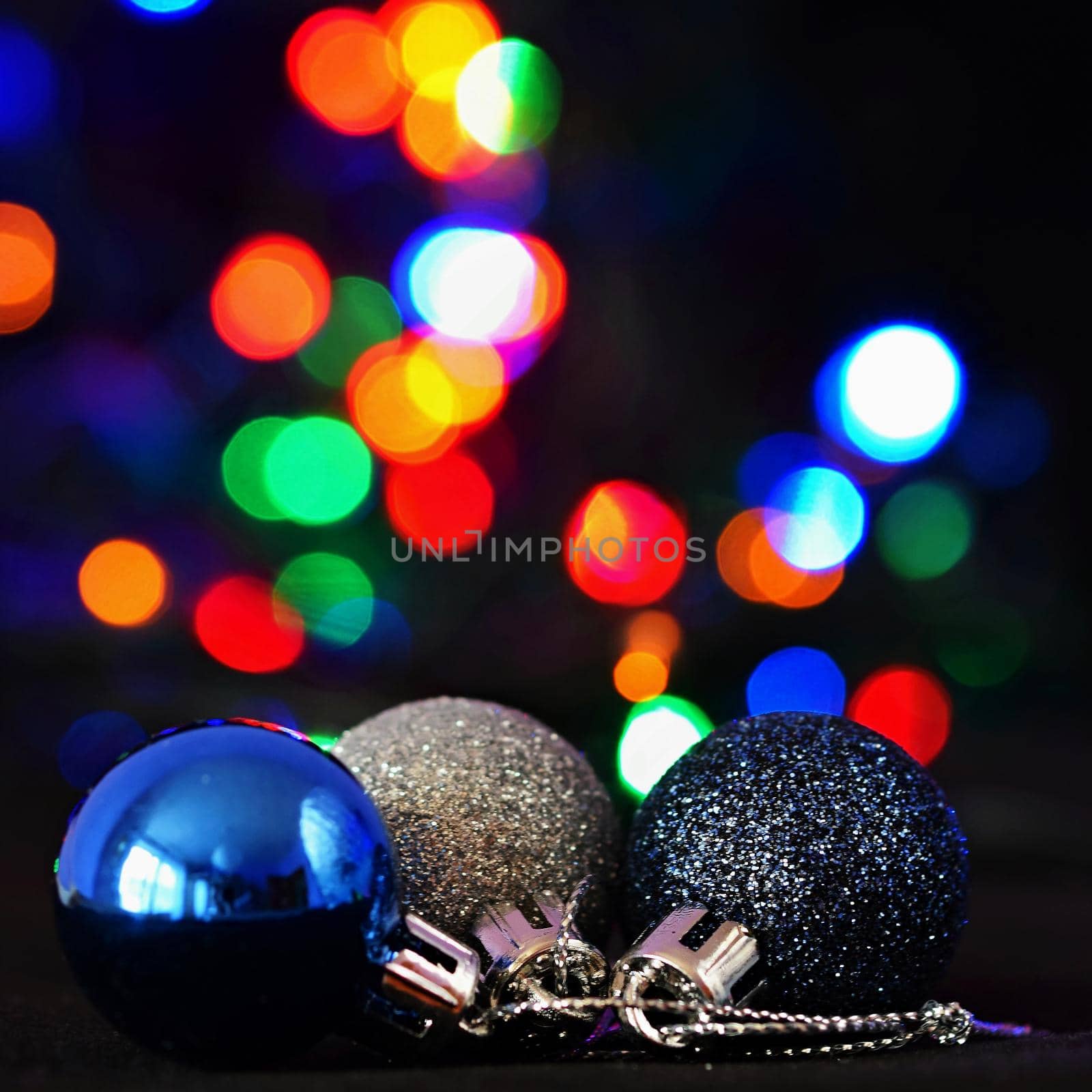 Colorful christmas Decoration. Winter holidays and traditional ornaments on a Christmas tree. Lighting chains - candles for seasonal background.