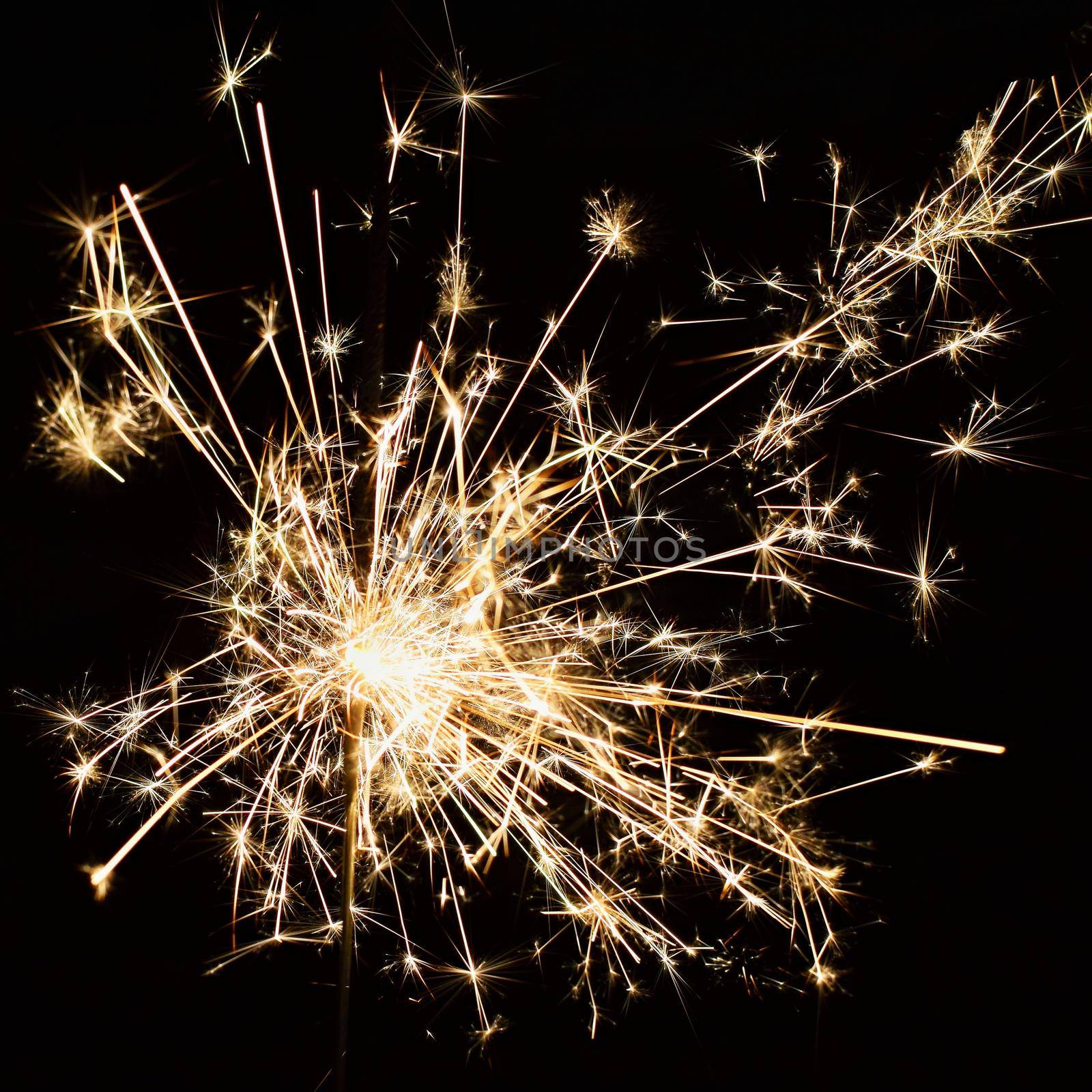 Beautiful Christmas - New Year background with sparkler and colorful lights.