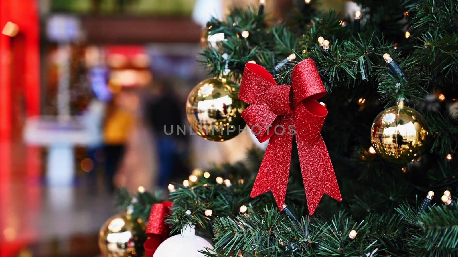 Colorful christmas Decoration. Winter holidays and traditional ornaments on a Christmas tree. Lighting chains - candles for seasonal background.