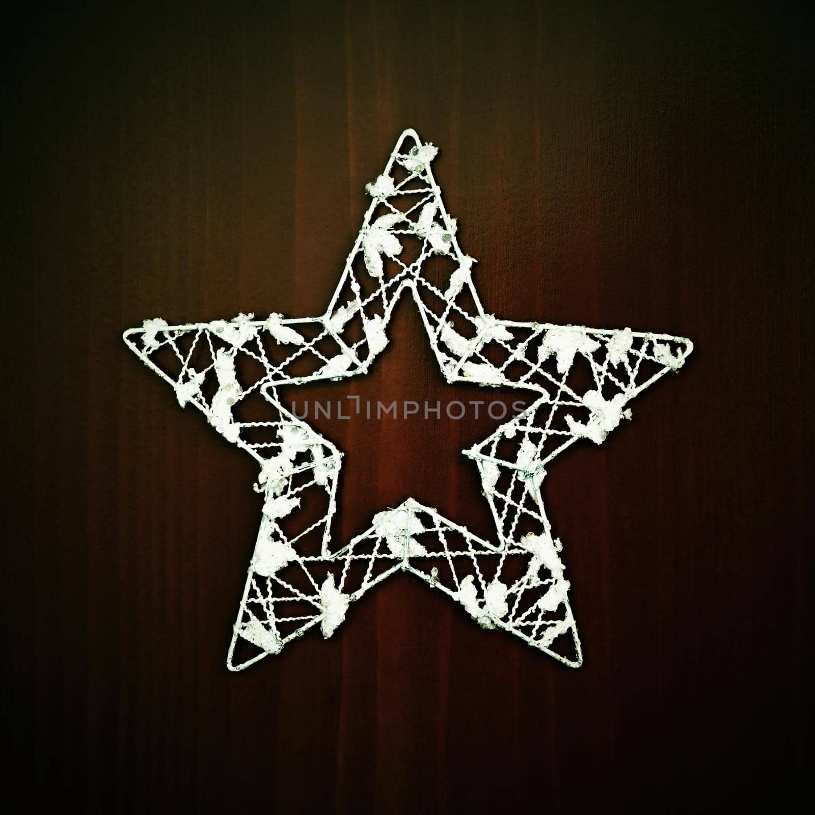 Christmas star ornament on a wooden background. Beautiful concept for Christmas time and winter.