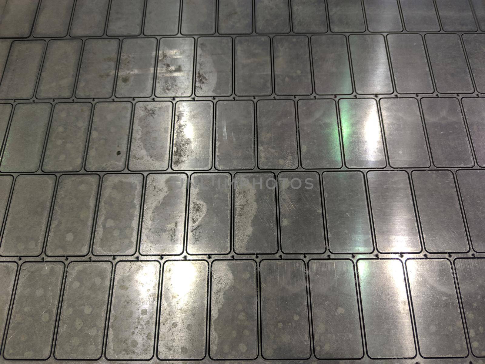full frame background of waterjet cutted parts in steel sheet.
