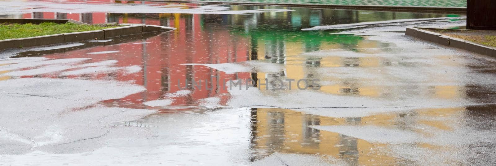 Puddle reflection of vintage apartment house in a rainy day.