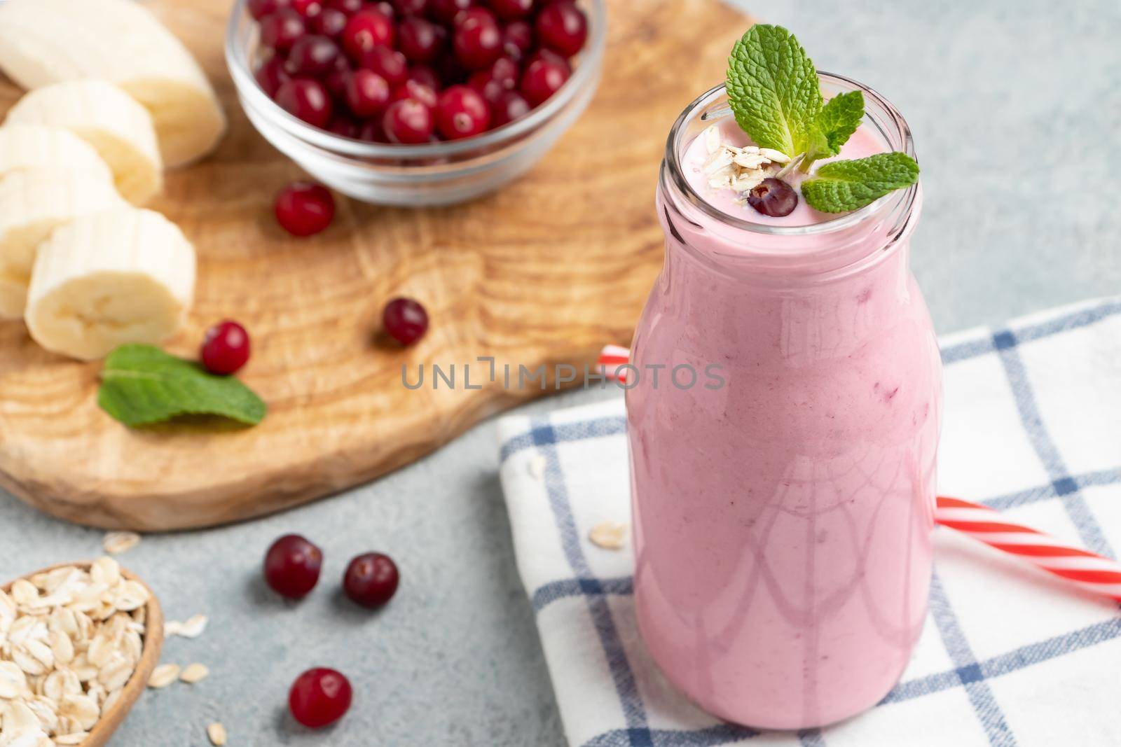 Homemade yogurt smoothie with banana, cranberry and oatmeal.