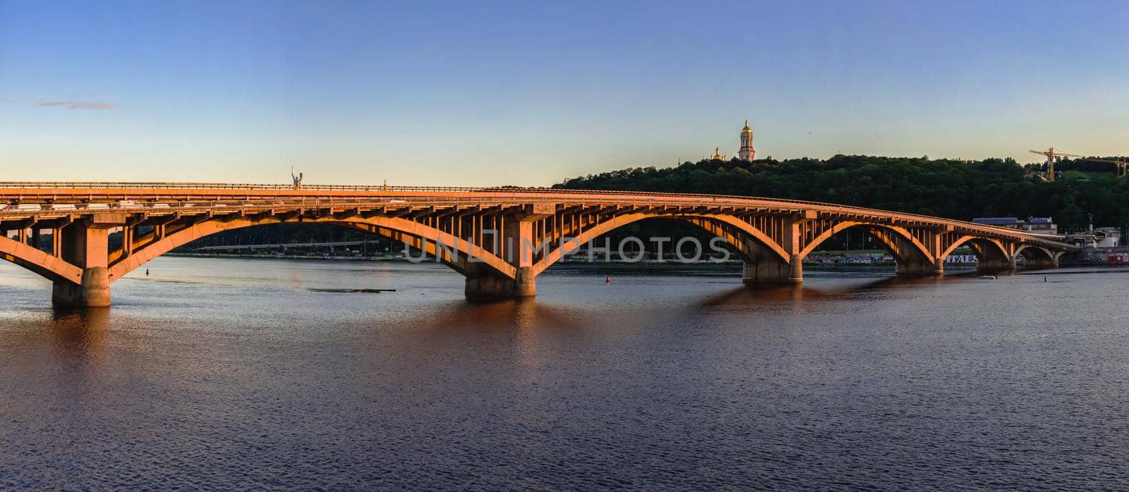 Kyiv, Ukraine 07.11.2020. Kyiv Metro bridge across the Dnieper river on a sunny summer evening.