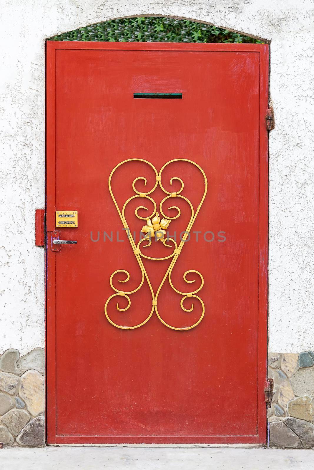 Red door with a code lock. Sunny autumn day. Front view. by Essffes