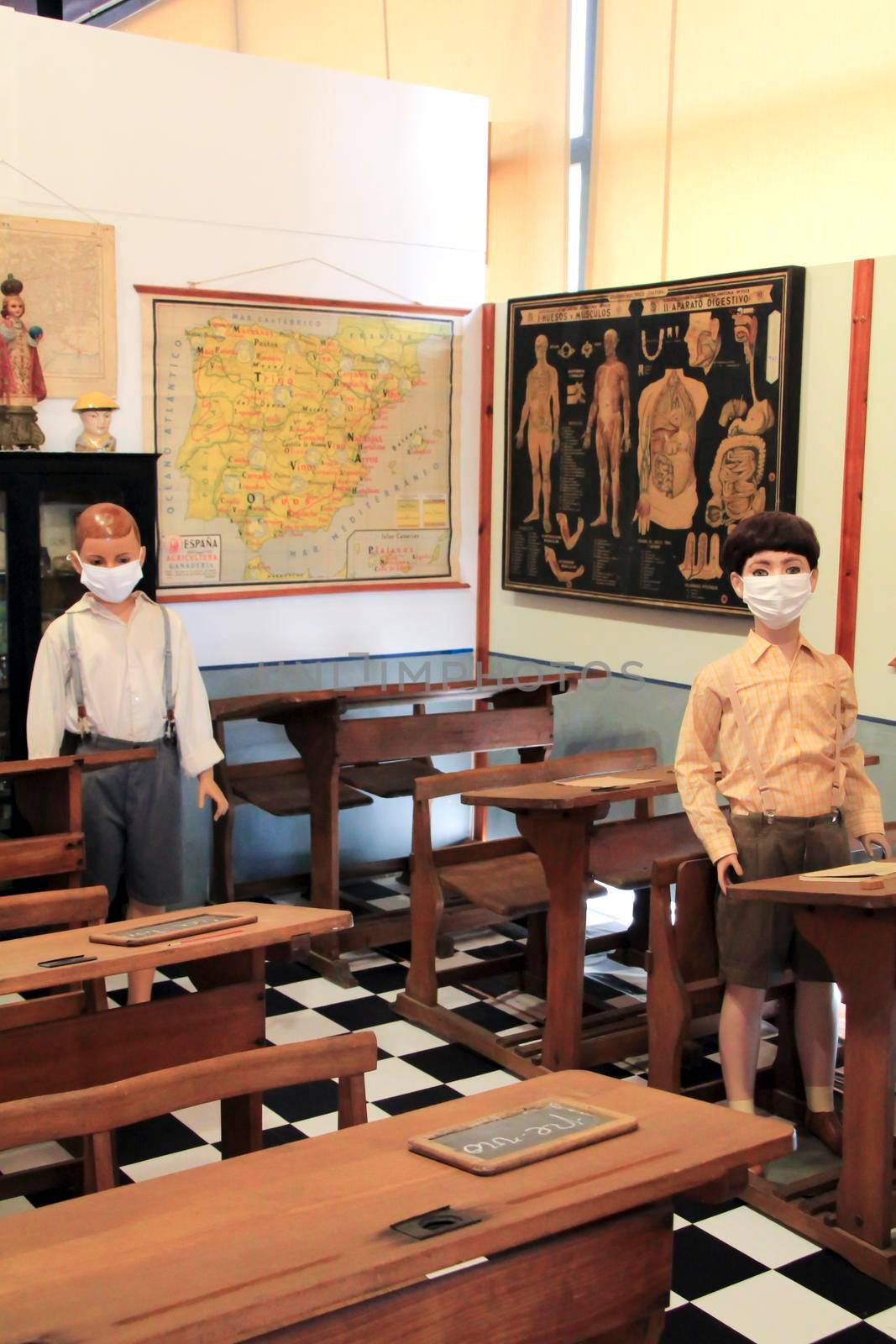 Elche, Alicante, Spain- March 28, 2021: Old school kids exhibited in life-size in the Pusol Museum of Elche