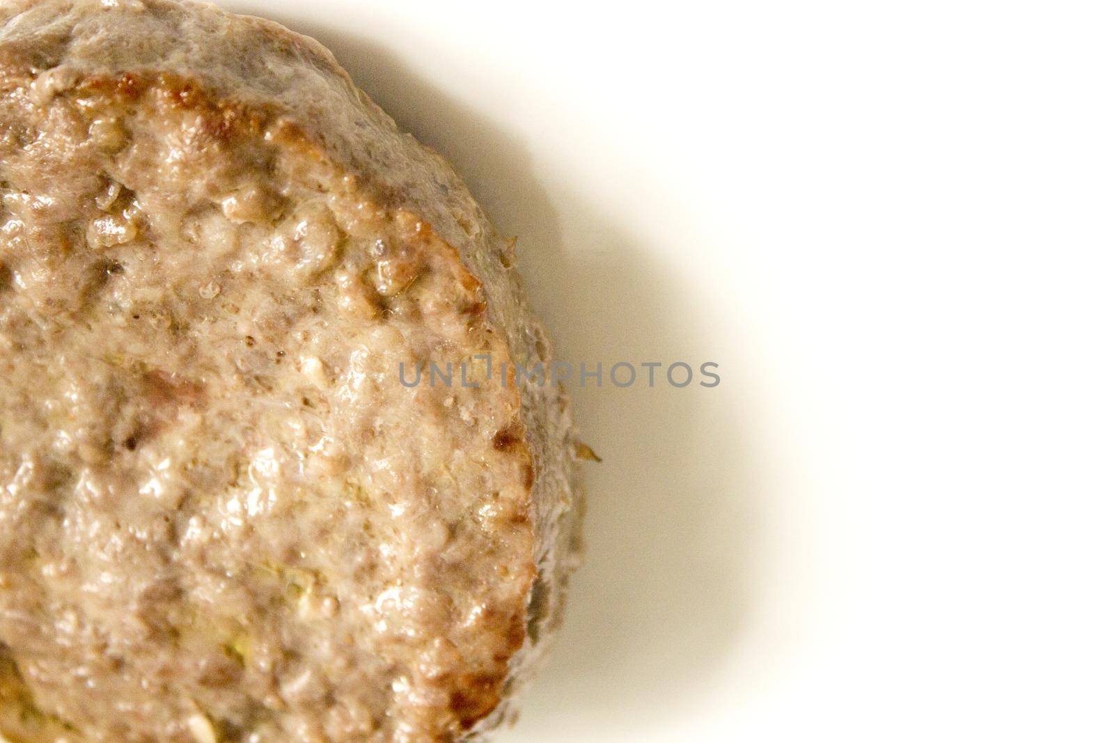 Organic beef burger on white plate. No people