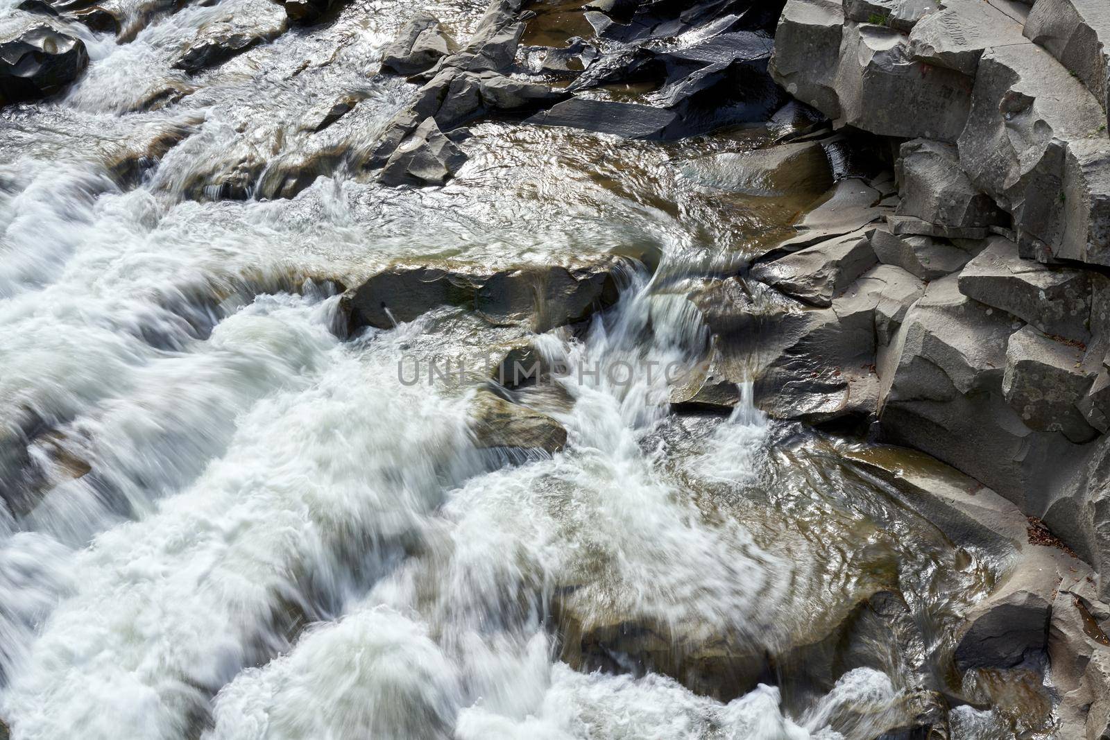 Mountain river with blured water close up by andreonegin