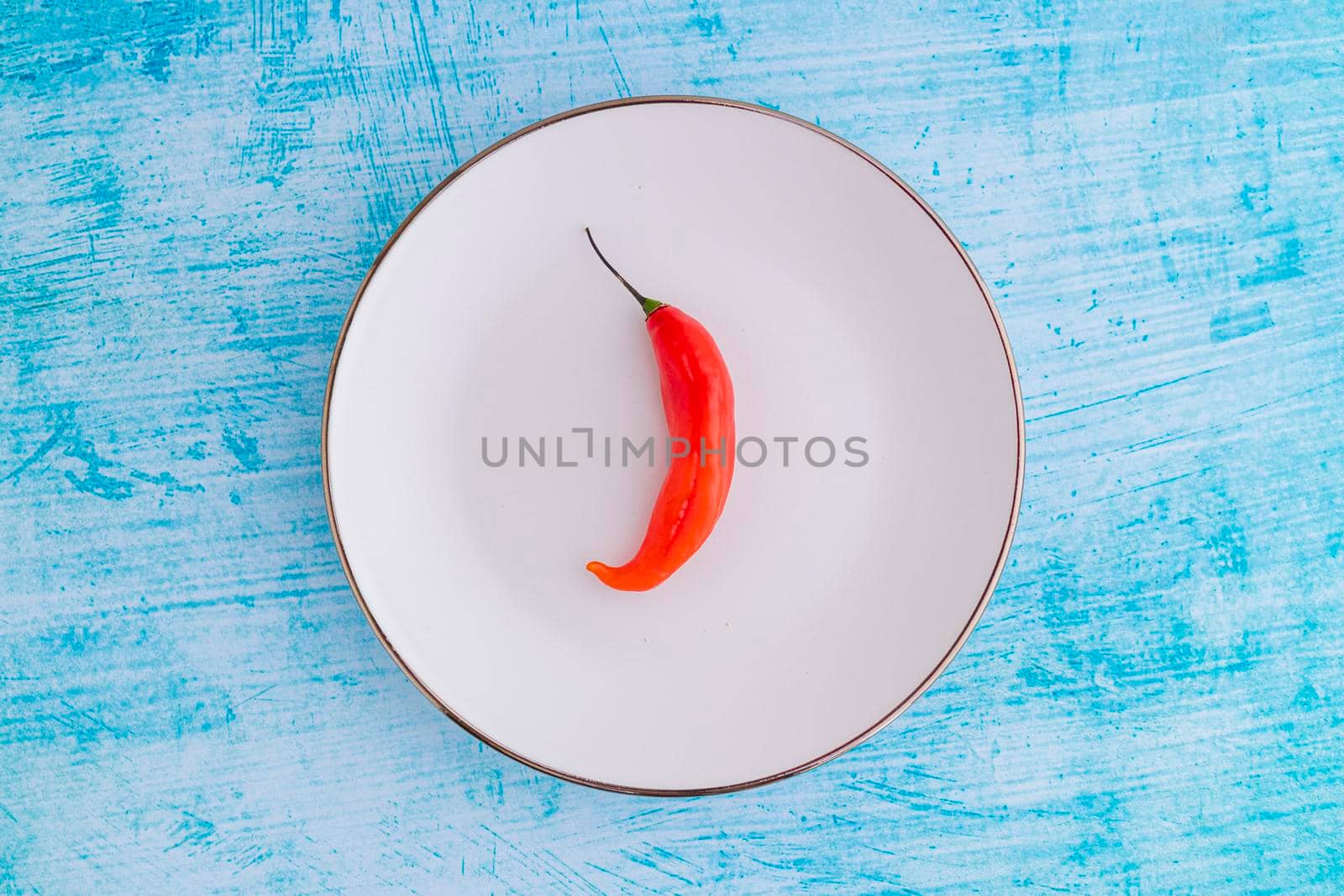 Presentation of the Peruvian red hot chili (Ají Limo) in a colored plate by eagg13