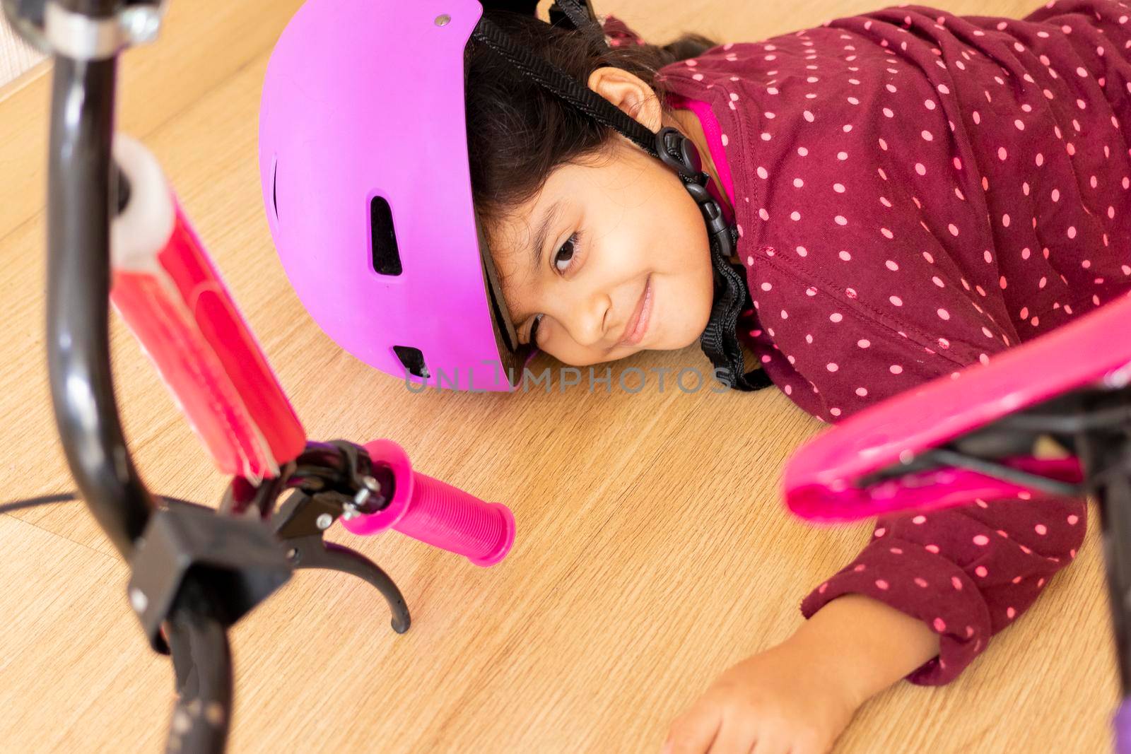 Sad little girl fell to the ground while playing with her bicycl by eagg13