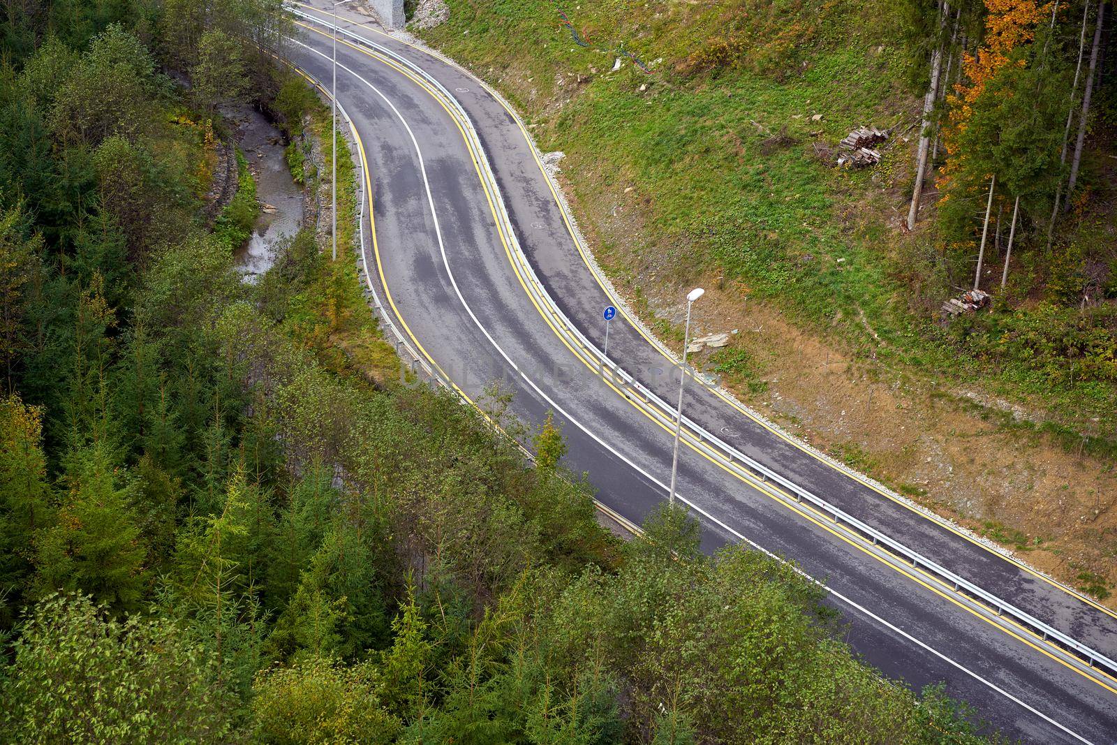 Mountain road Aerial view of road through forest by andreonegin