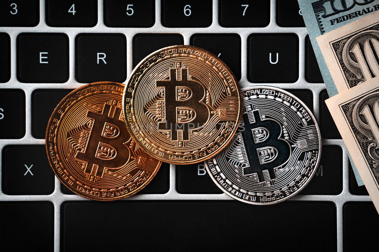 Bitcoin. Business top view cryptocurrency design concept with USD Dollar paper currency money on laptop over dark black table background.