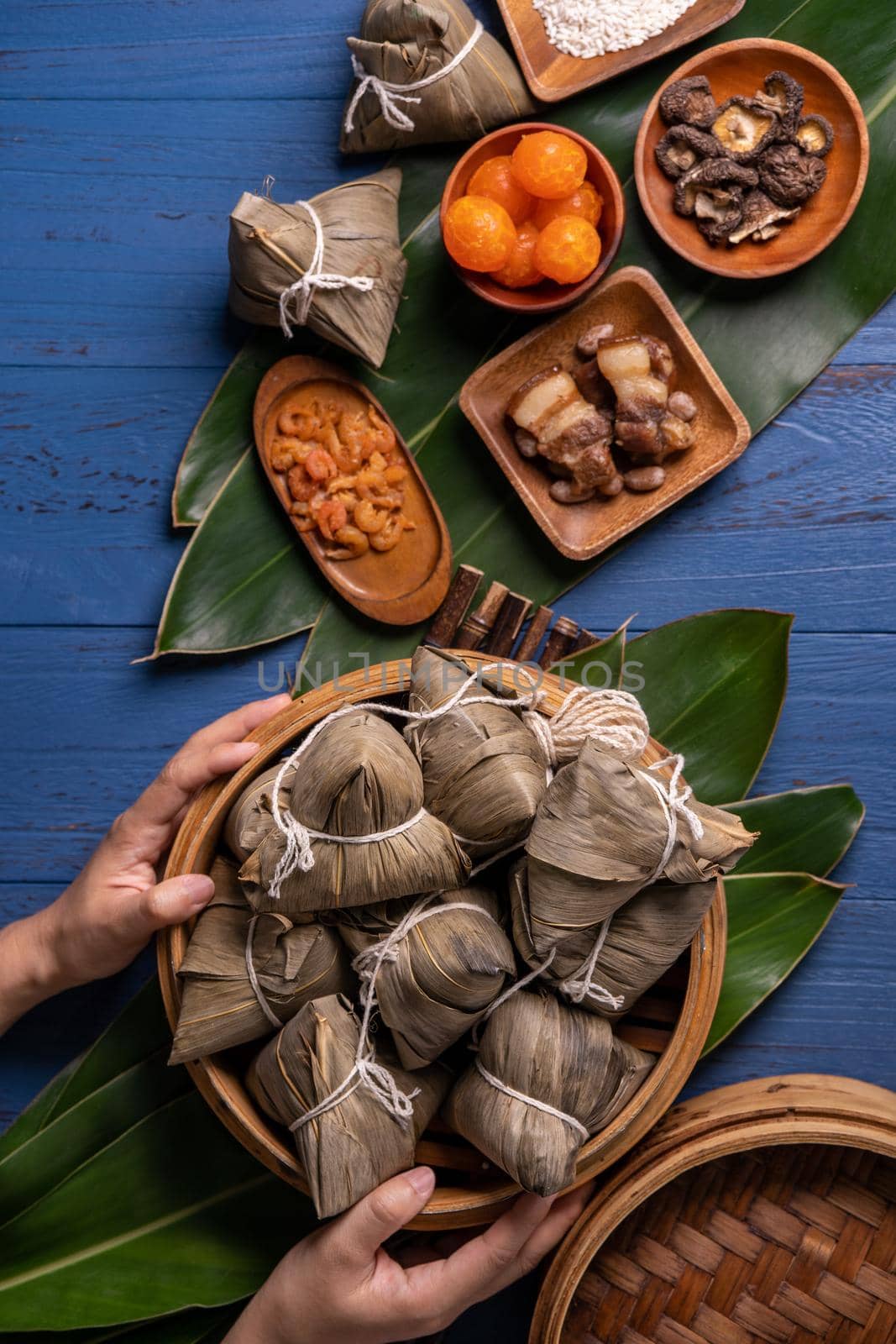 Zongzi rice dumpling with ingredients top view for Chinese traditional Dragon Boat Festival (Duanwu Festival) over blue wooden table background.