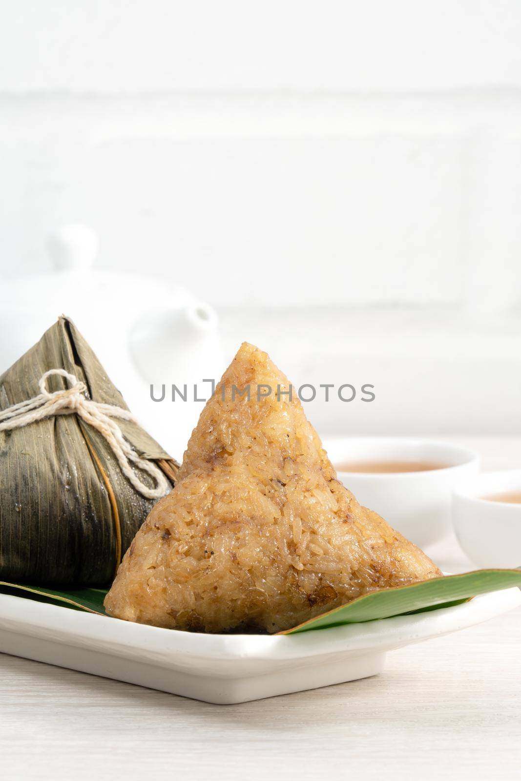 Zongzi. Rice dumpling for Chinese traditional Dragon Boat Festival (Duanwu Festival)  on bright wooden table background.