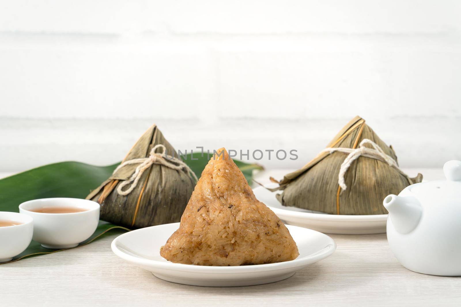 Zongzi. Rice dumpling for Chinese traditional Dragon Boat Festival (Duanwu Festival)  on bright wooden table background.