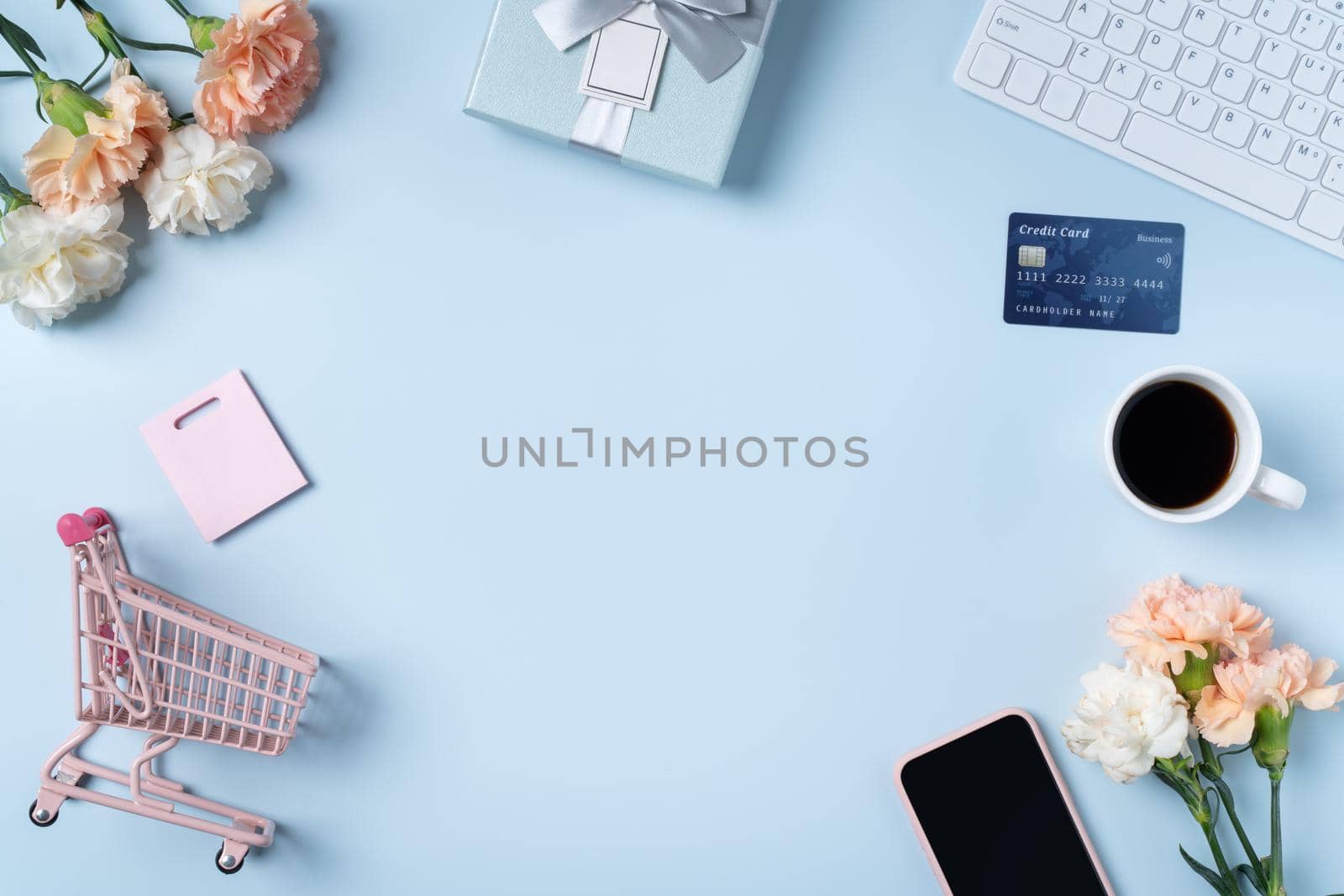 Mother's day buying gift design concept with carnation flower on office blue table desk background.