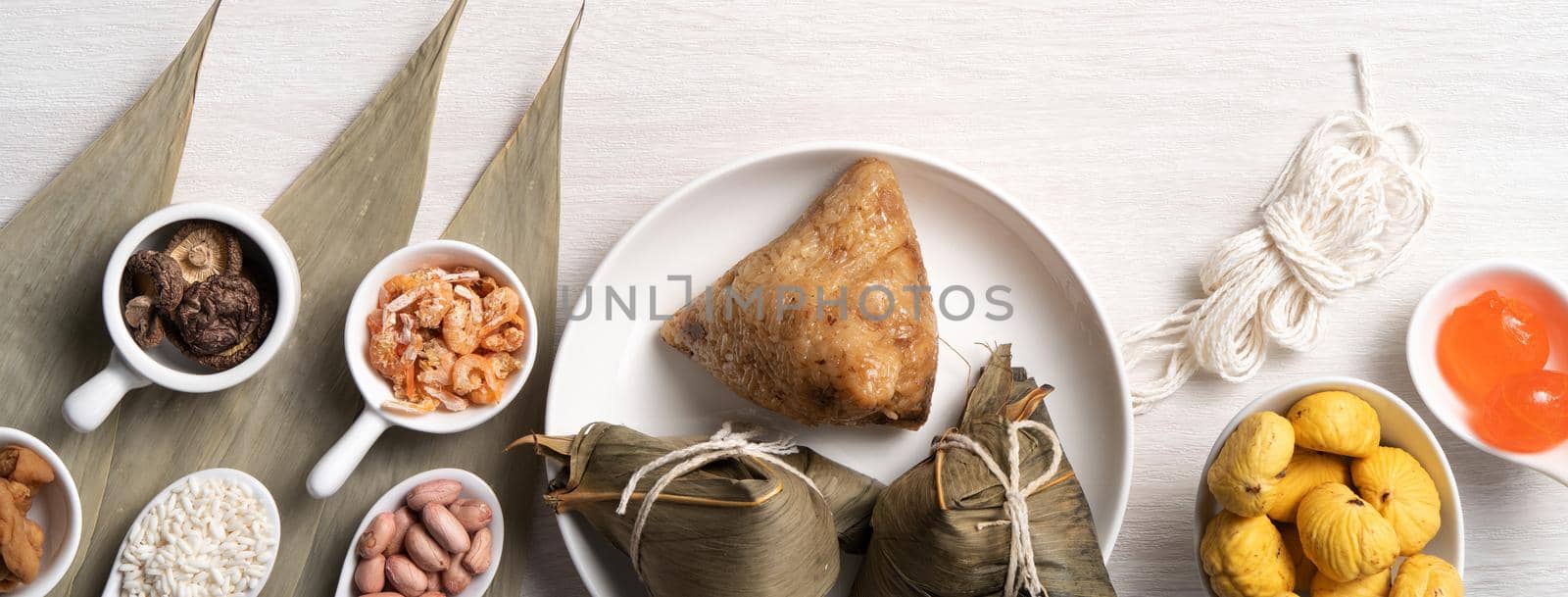 Zongzi. Delicious traditional rice dumpling food for Dragon Boat Duanwu Festival over wooden table background top view.