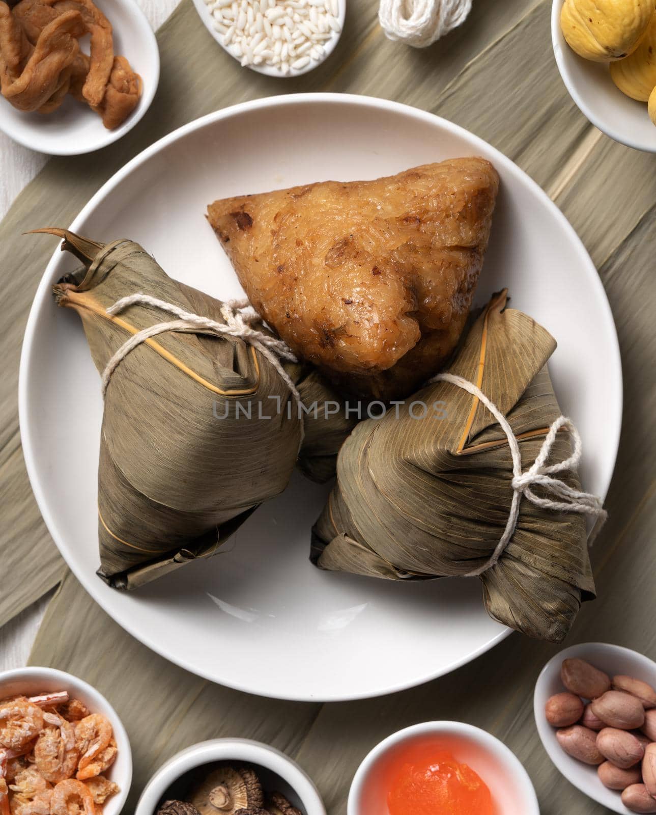 Zongzi. Delicious traditional rice dumpling food for Dragon Boat Duanwu Festival over wooden table background top view.