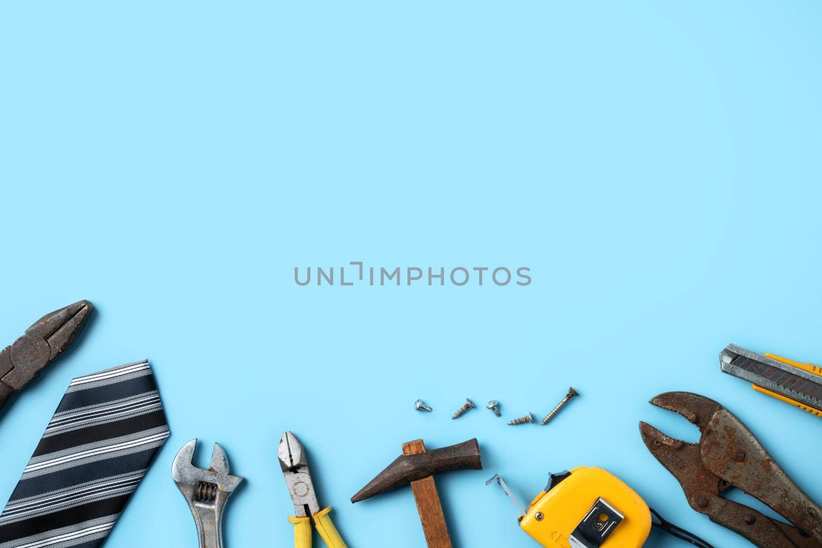 Father's Day design concept. Top view of Father's and labor day with working tools on blue background.