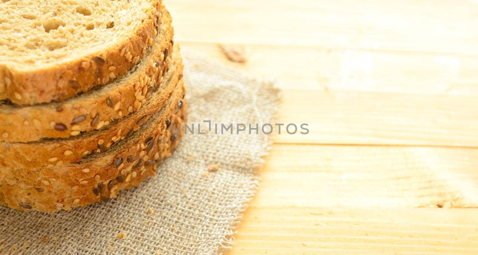 Several slices of cereal bread on a wooden background,copyspace.